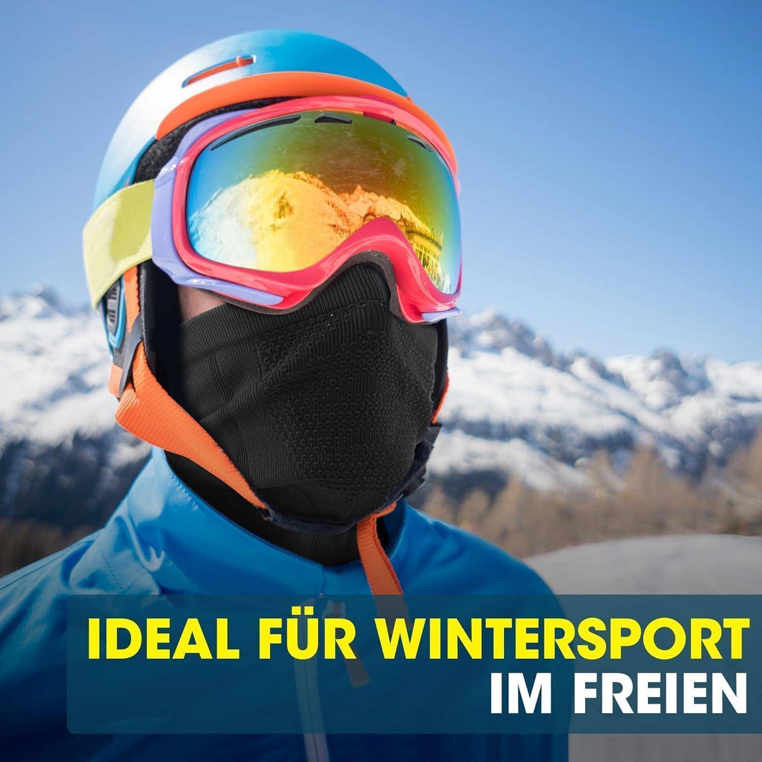 Skifahrer mit Helm, der verspiegelte Skibrillen und Gesichtsschutz trägt, mit verschneiten Bergen im Hintergrund; der Text lautet „IDEAL FÜR WINTERSPORT IM FREIEN