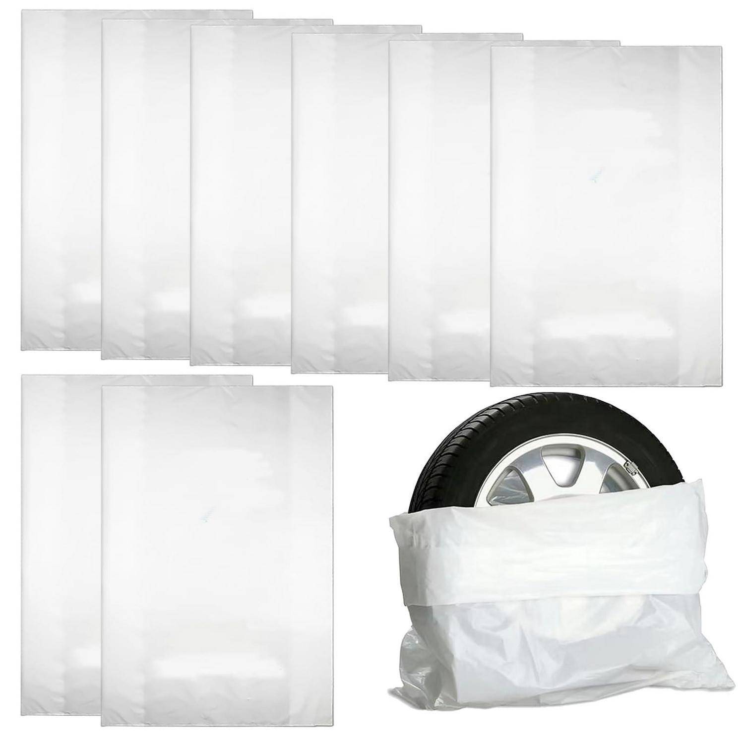 Weiße Kunststoff-Einkaufstasche, plus ein Stapel flacher weißer Kunststofftaschen und zwei gefaltete Taschen neben einem Reifen, die Verpackung und Lagerung von Taschen zeigen.
