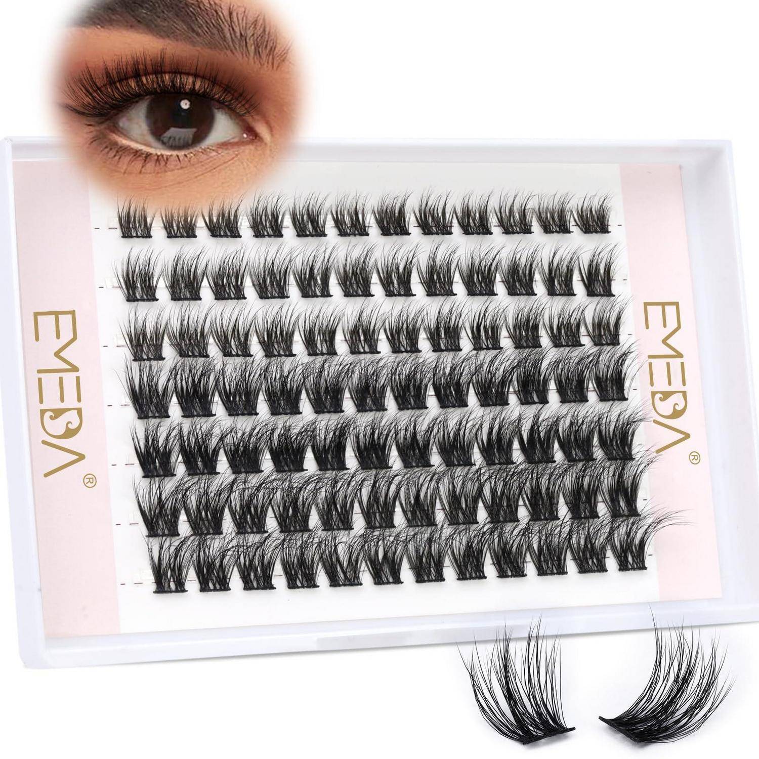 Packung mit falschen Wimpernstreifen mit einem Augenbeispiel, das die dramatische Wimperneffekt zeigt, plus zwei lose Wimpern darunter.
