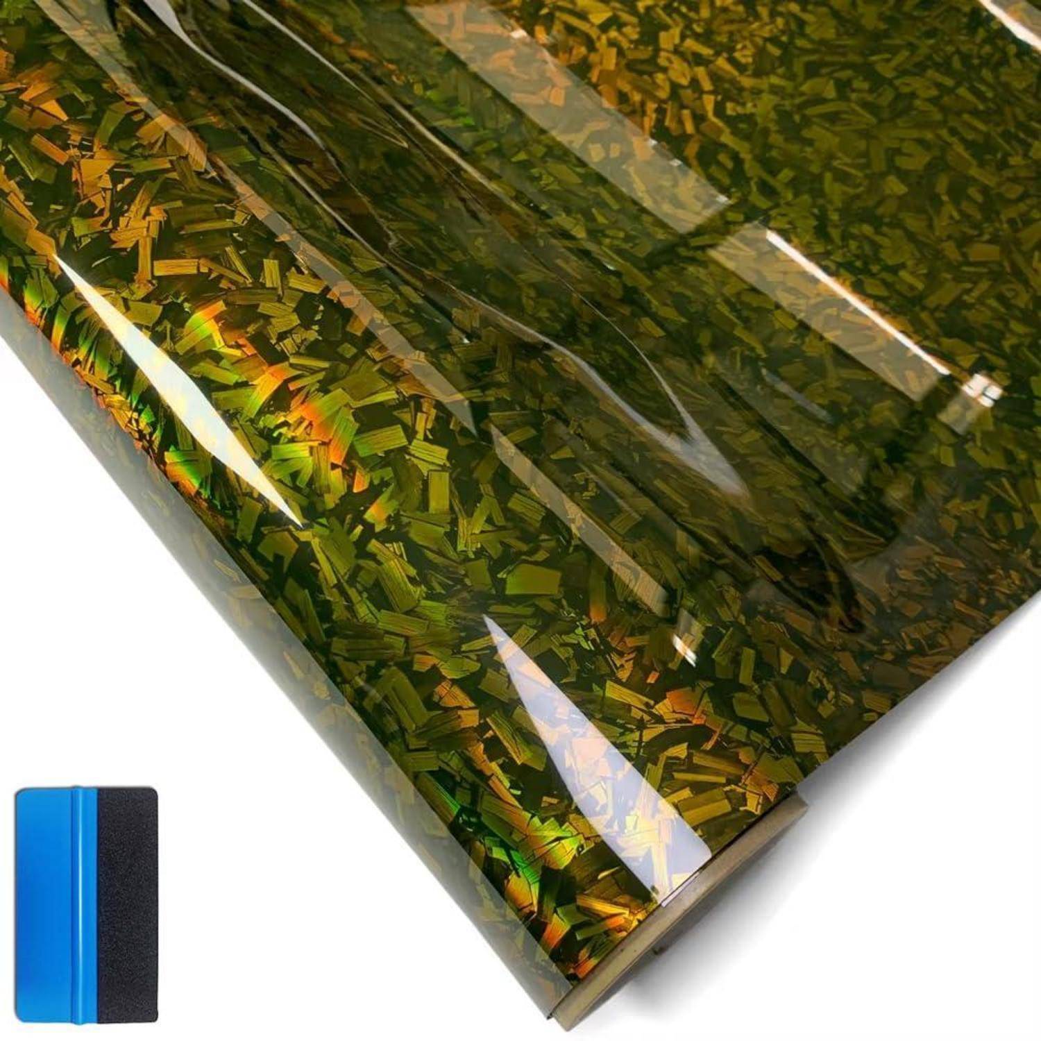 Reflektive olivgrün schillernde gemusterte Filmrolle mit einer blau-schwarzen Mustermuster auf weißem Hintergrund.