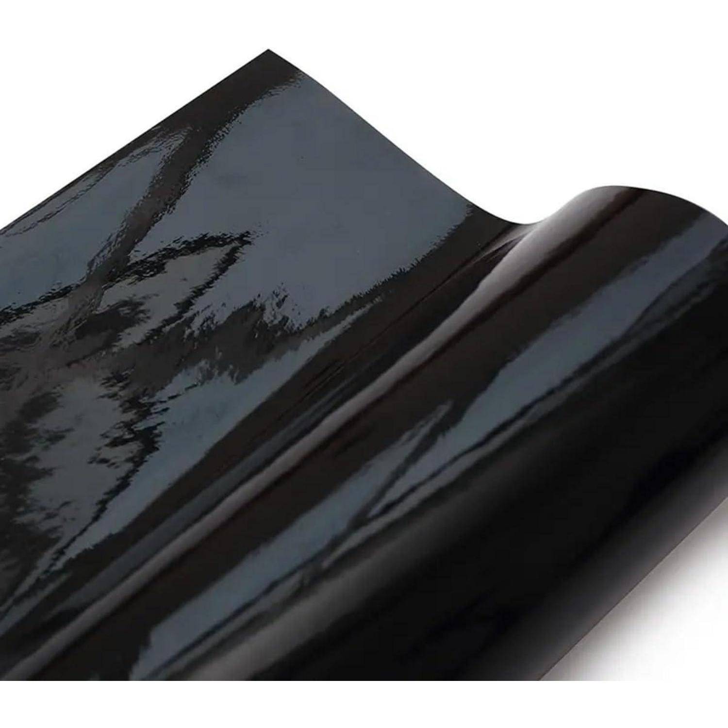 Glänzendes schwarzes Rollenmaterial mit glatter, reflektierender Oberfläche, in Nahaufnahme vor weißem Hintergrund dargestellt.