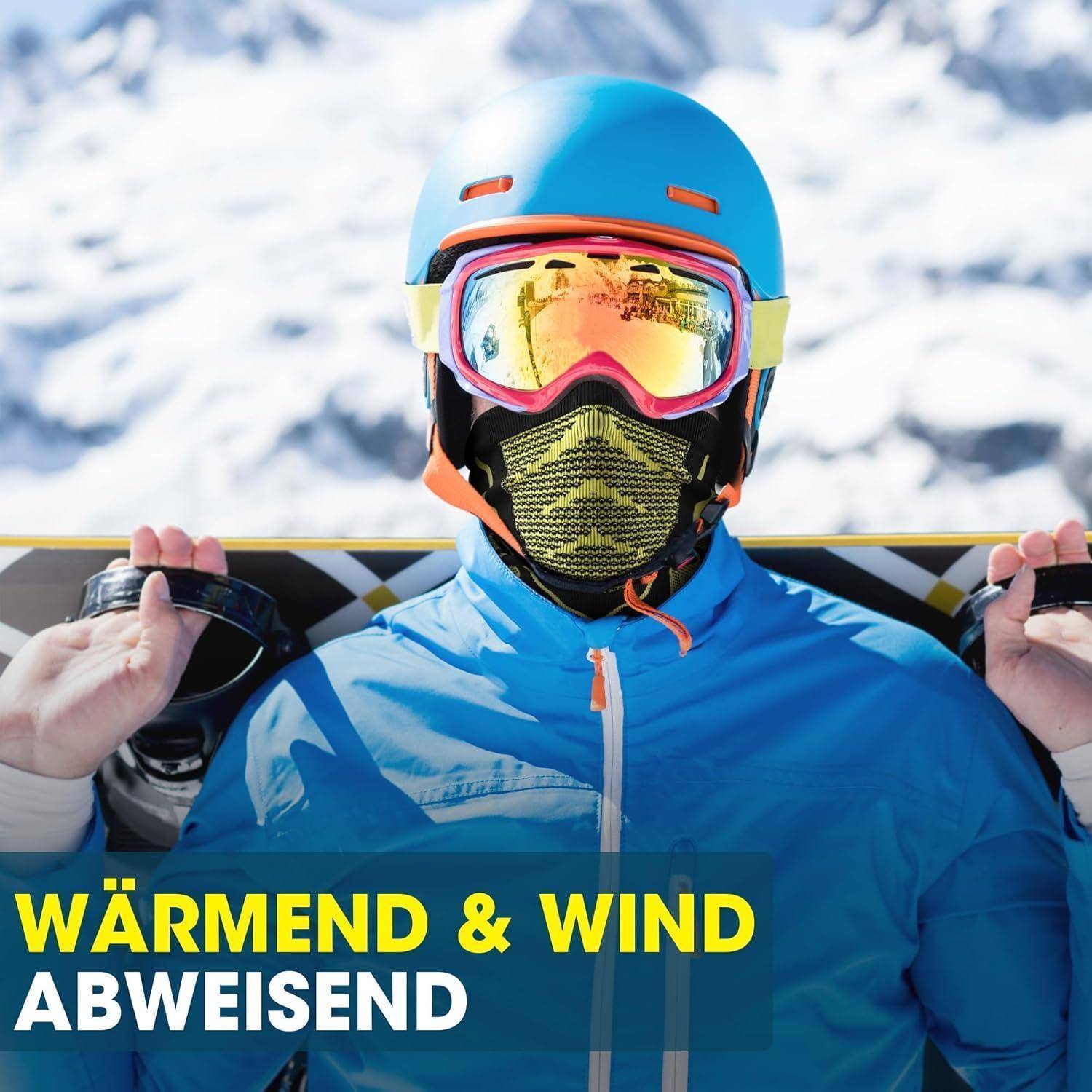 Skifahrer in blauer Ausrüstung mit Helm, Schutzbrille und Gesichtsmaske hält ein Snowboard; Text lautet „WÄRMEND & WIND ABWEISEND