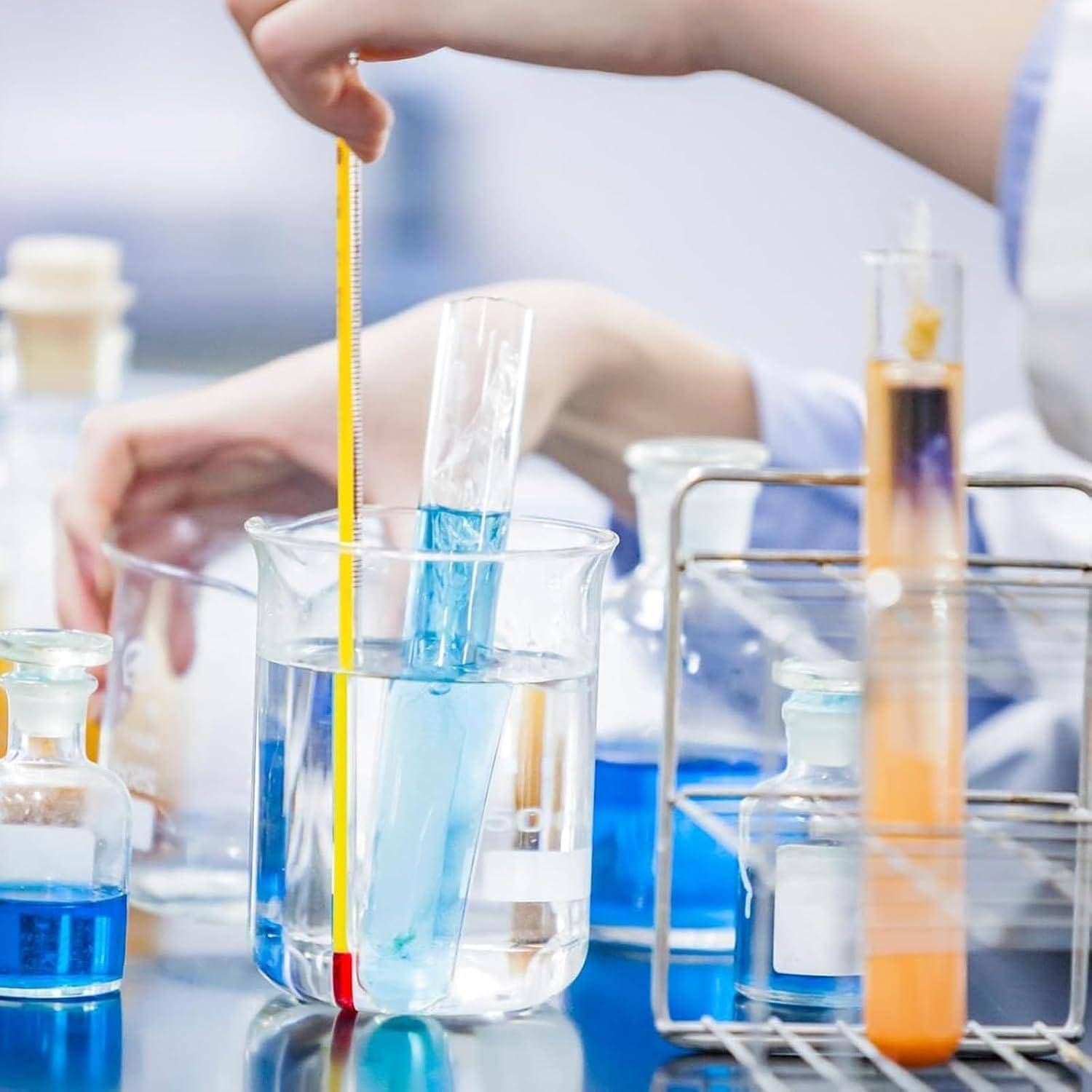 Wissenschaftler, der ein Thermometer in einem Labor verwendet, mit Bechergläsern und Reagenzgläsern, die blaue und orange Flüssigkeiten auf einer Werkbank enthalten.