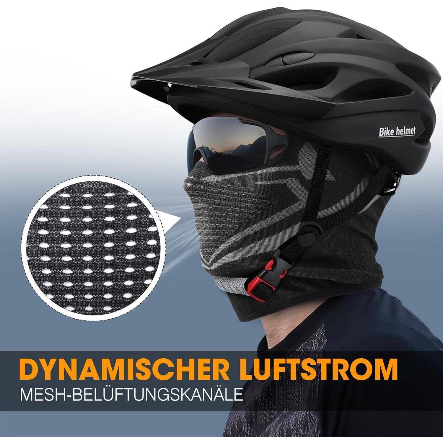 Person trägt schwarzen Fahrradhelm und Gesichtsschutzmaske; Ausschnitt zeigt Mesh-Belüftungsmuster. Text lautet „DYNAMISCHER LUFTSTROM" und „MESH-BELÜFTUNGSKANÄLE"".