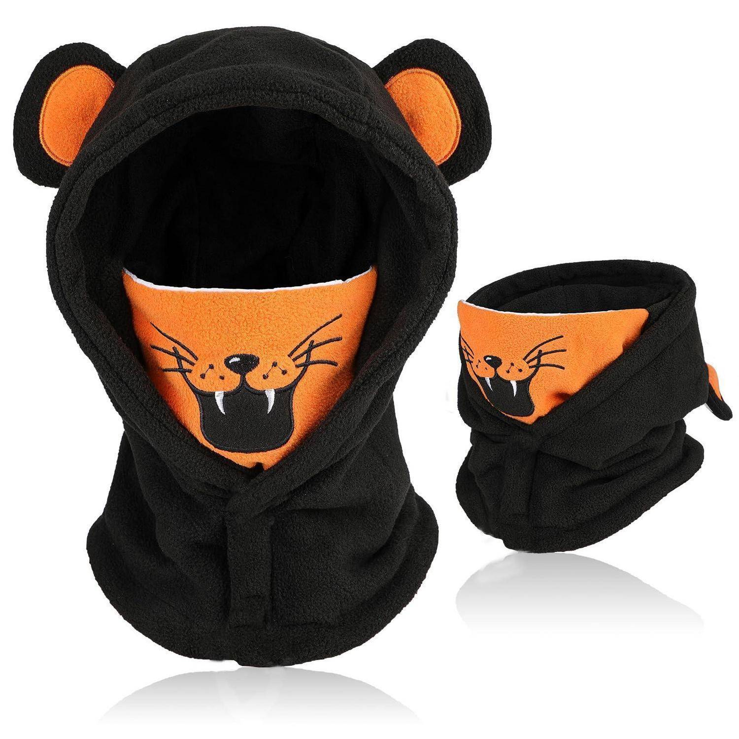 Schwarze kapuzenförmige Tiermaske mit orangefarbenen Bärenohren und bedruckter knurrender Tiger-/Katzengesichtsöffnung, von vorne und eingeklappter Seitenansicht gezeigt.