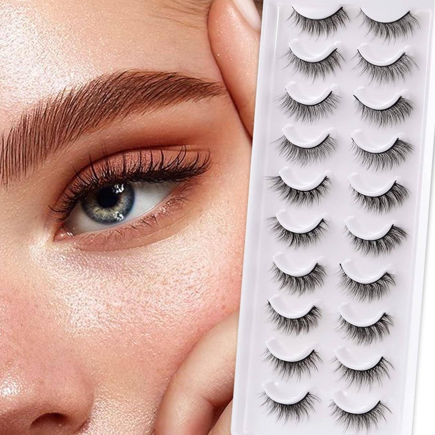 Nahaufnahme eines Frauenauges neben einem Tablett mit Paaren von künstlichen Wimpern, das verschiedene Wimpernstile zur Anwendung zeigt.