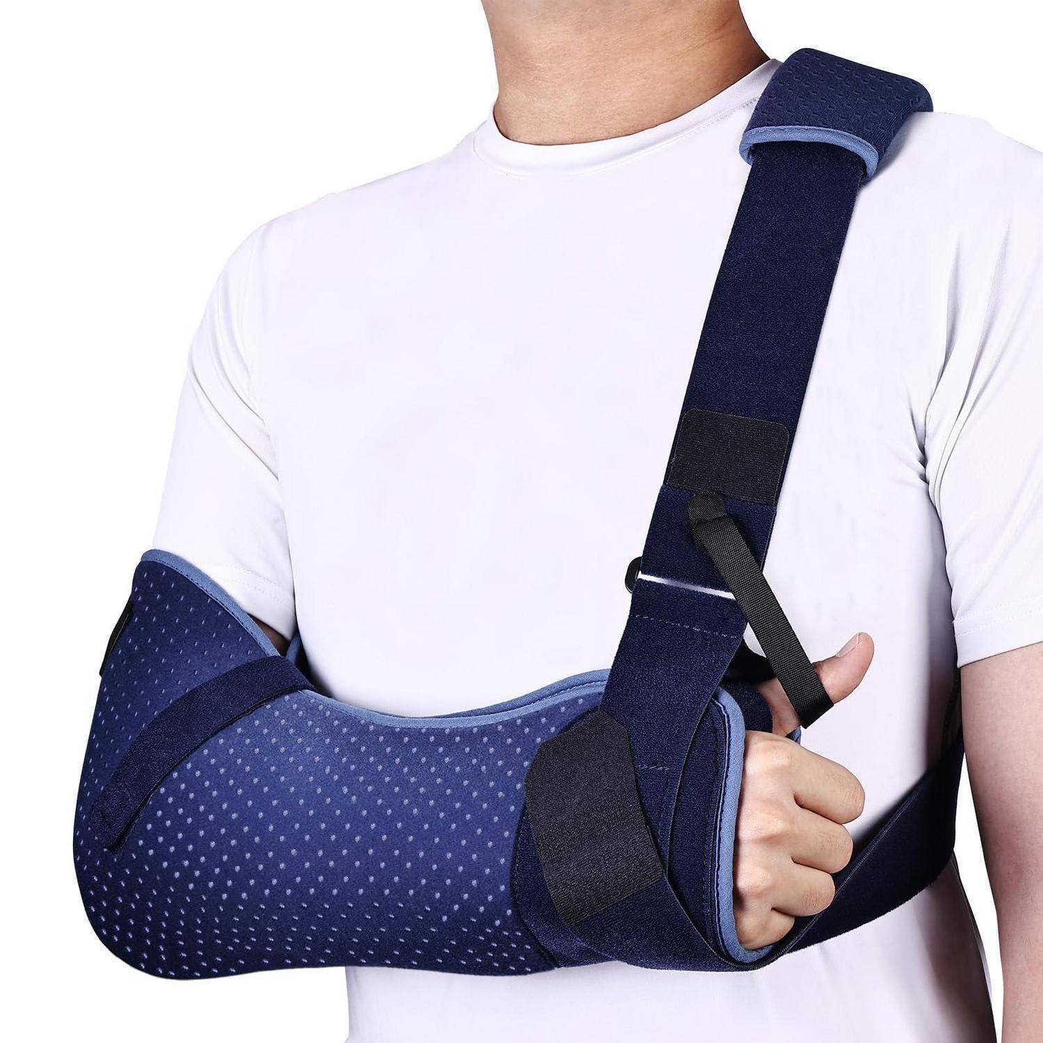 Person mit blauer Armschlinge und Ellbogenbandage, mit dem Unterarm gestützt und über die Brust gespannt.
