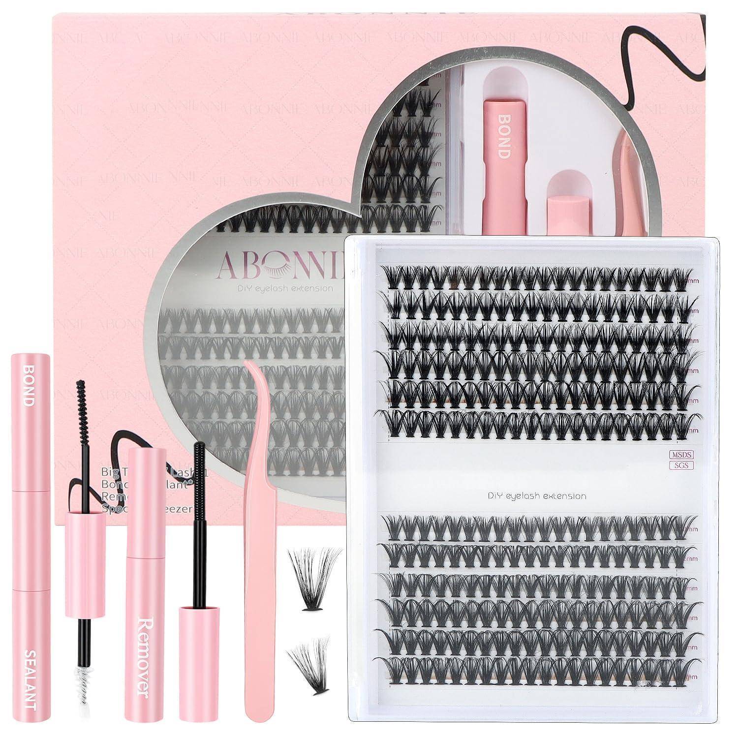 Rosa Wimpernverlängerungssatz mit Klebstofftuben, Applikatoren und schwarzen Wimpernbündeln in Tabletts in einem durchsichtigen Behälter.