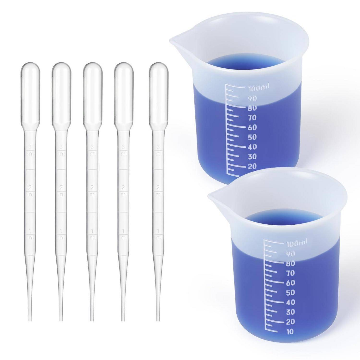 Fünf klare Kunststoff-Pipetten neben zwei blauen Flüssigkeits-Messbechern mit Milliliter-Markierungen.