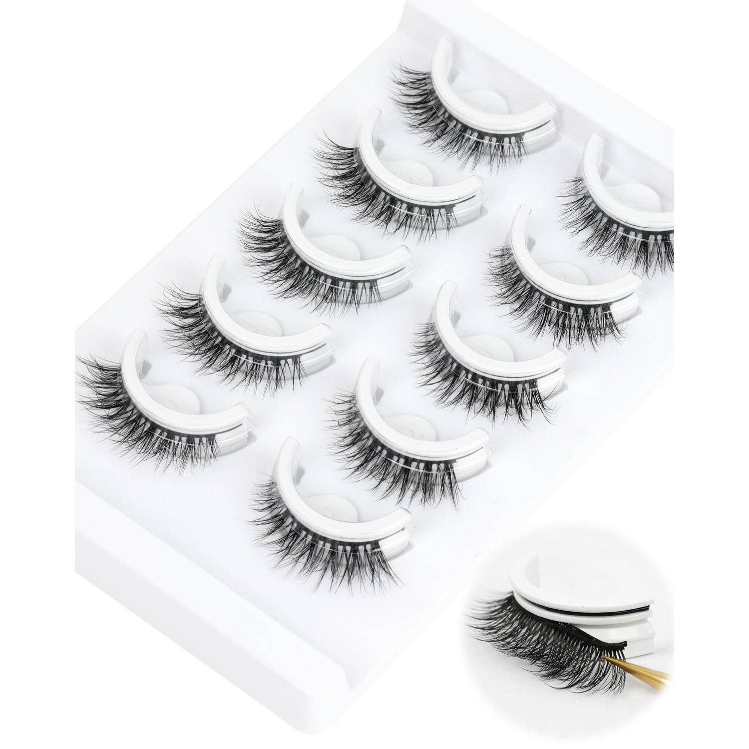Satz von künstlichen Wimpern auf einem weißen Tablett ausgestellt, mit einer vergrößerten Einfügung, die eine Pinzette zeigt, die einen Wimpernstreifen anbringt.