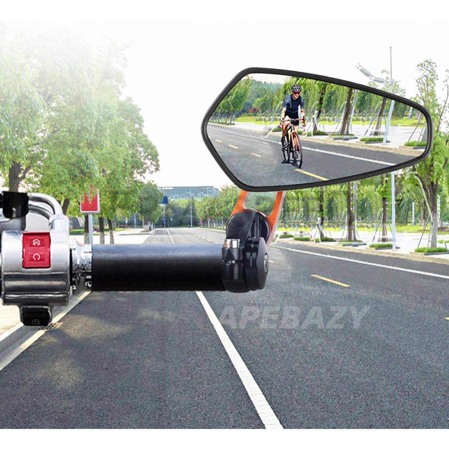 Motorradlenker mit Rückspiegel, der einen Radfahrer zeigt, der auf einer von Bäumen gesäumten Straße fährt
