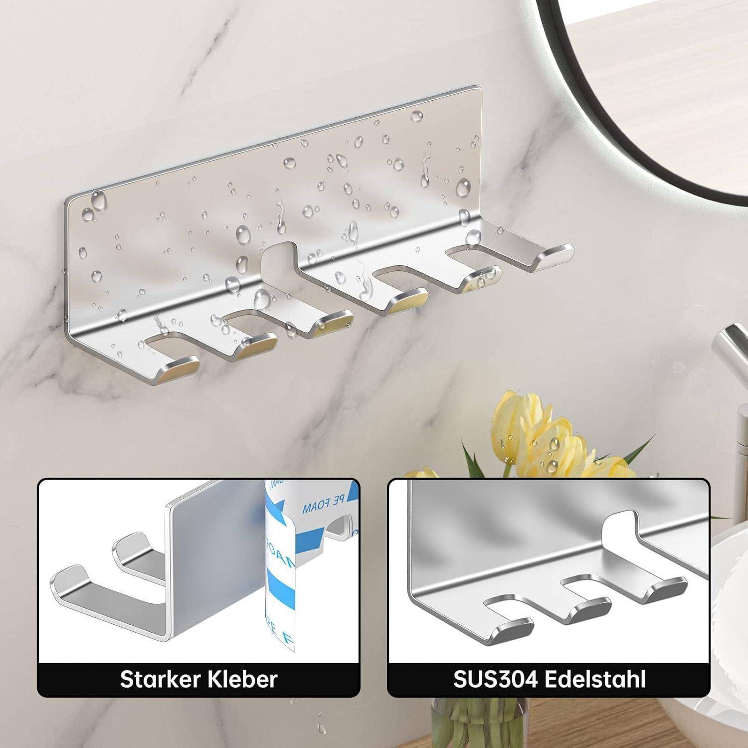 Chrom-Wandhalter mit vier Haken an einer Marmor-Badezimmerwand; eingefügte Beschriftungen vergleichen Klebehalterung und SUS304-Edelstahlfinish.