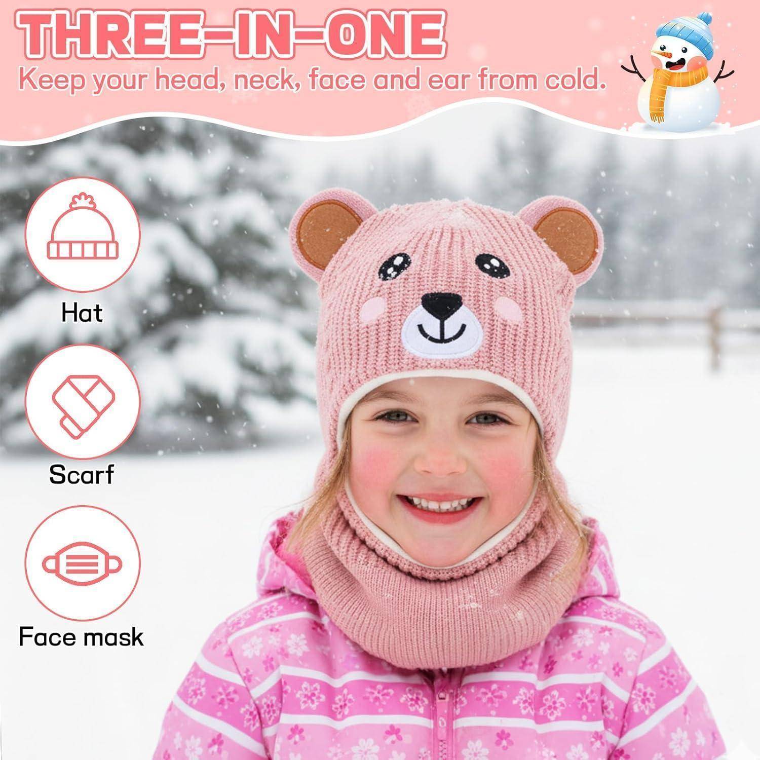 Kind trägt eine rosa Bärenmütze und einen passenden Halswärmer; die Anzeige zeigt ein 3-in-1-Winterset für Mütze, Schal und Gesichtsmaske, um Kopf, Hals, Gesicht und Ohren warm zu halten.