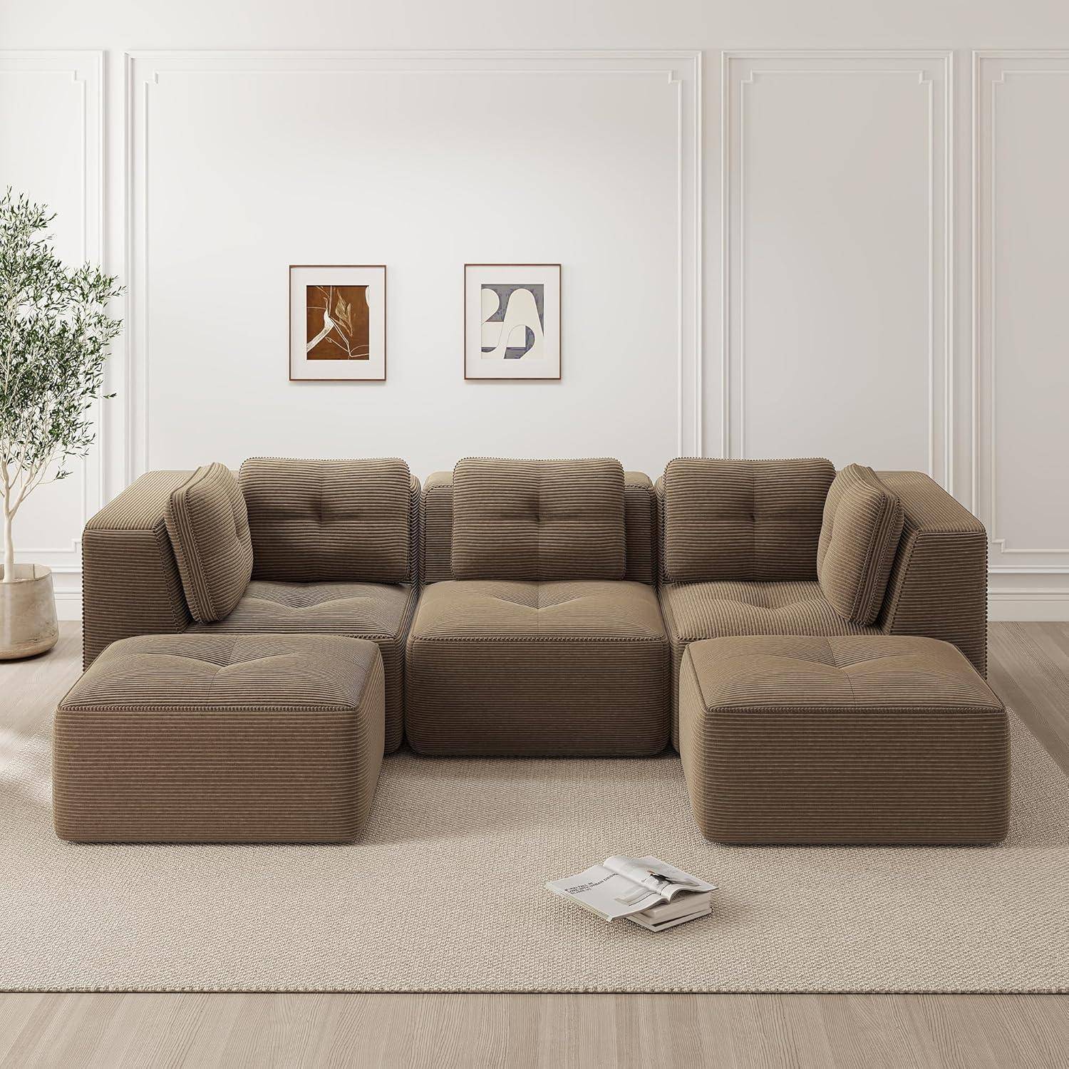 Braunes modulares Ecksofa mit Chaiselongue in einem minimalistischen Wohnzimmer, mit Bilderrahmen an der Wand, einer Pflanze und Zeitschriften auf einem hellen Teppich.