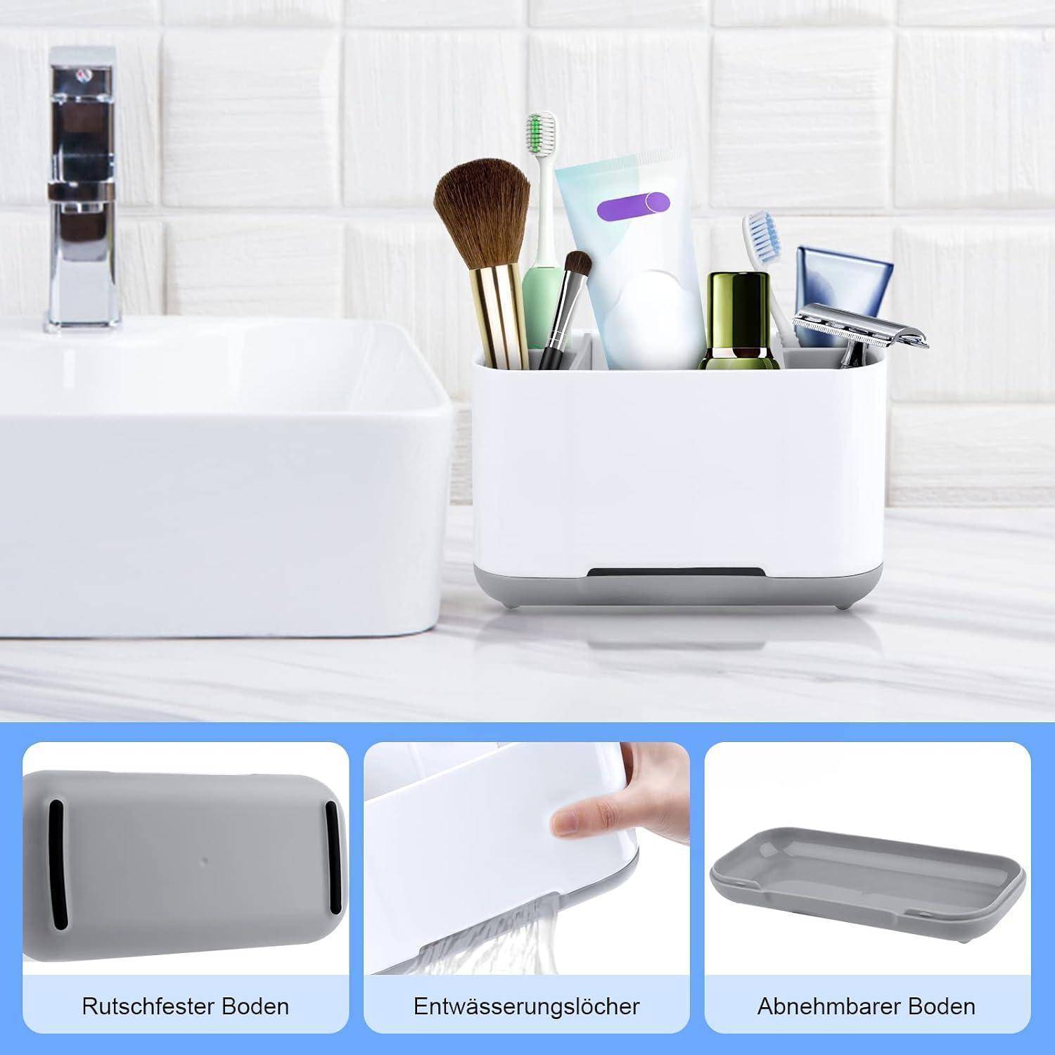 Badezimmerorganizer für Makeup-Pinsel, Zahnbürsten, Zahnpasta, Nagelwerkzeuge und einen Rasierer, mit eingefügten Beschriftungen, die die rutschfeste Basis, Entwässerungslöcher und den abnehmbaren Boden zeigen.