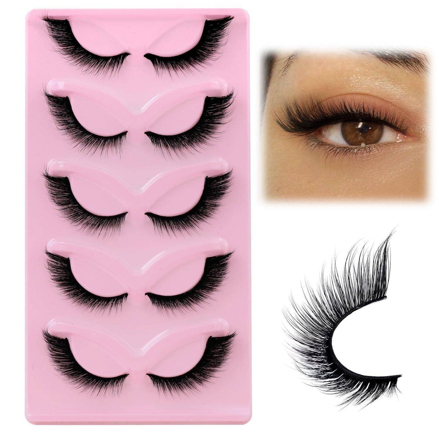 Rosa Tablett mit fünf Paaren falscher Wimpern, mit einer Nahaufnahme eines Auges mit Wimpern und einem einzelnen Wimpernstreifen auf weißem Hintergrund.