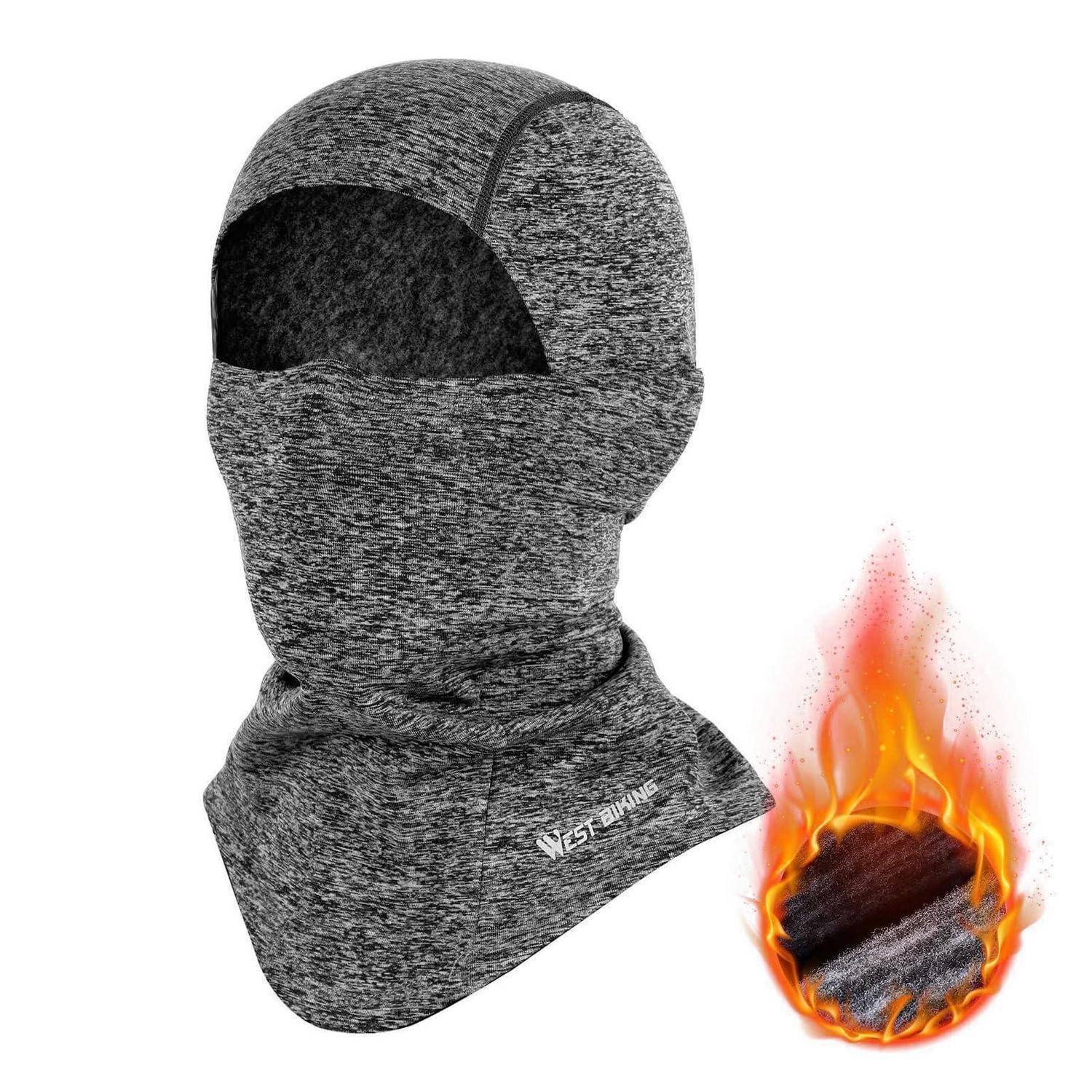 Graue Wintermütze mit Gesichtsmaske und Augenöffnung sowie Nackenbedeckung, daneben ein Flammensymbol, das feuerfestes Material anzeigt.