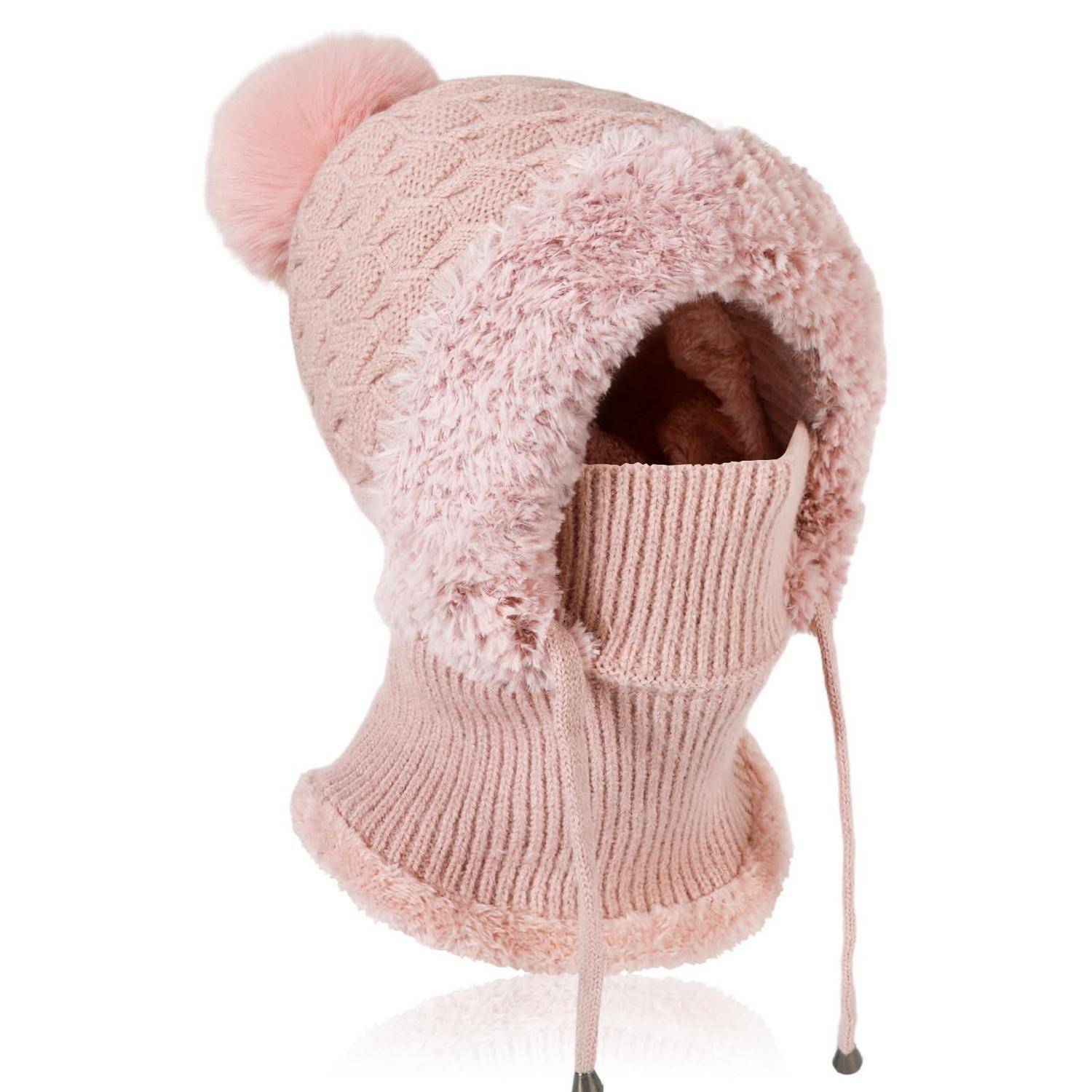 Rosa flauschige Strickwintermütze für Babys mit Ohrenklappen, Pompon und Kinnbändern auf weißem Hintergrund.