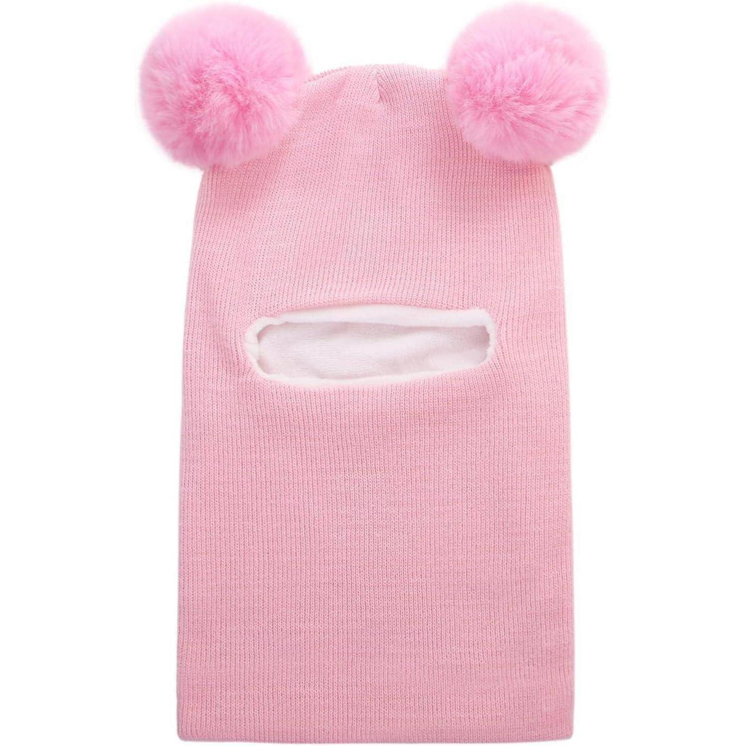 Rosa gestrickte Sturmmaske mit zwei flauschigen Bommel auf der Oberseite und einer horizontalen Gesichtsöffnung.
