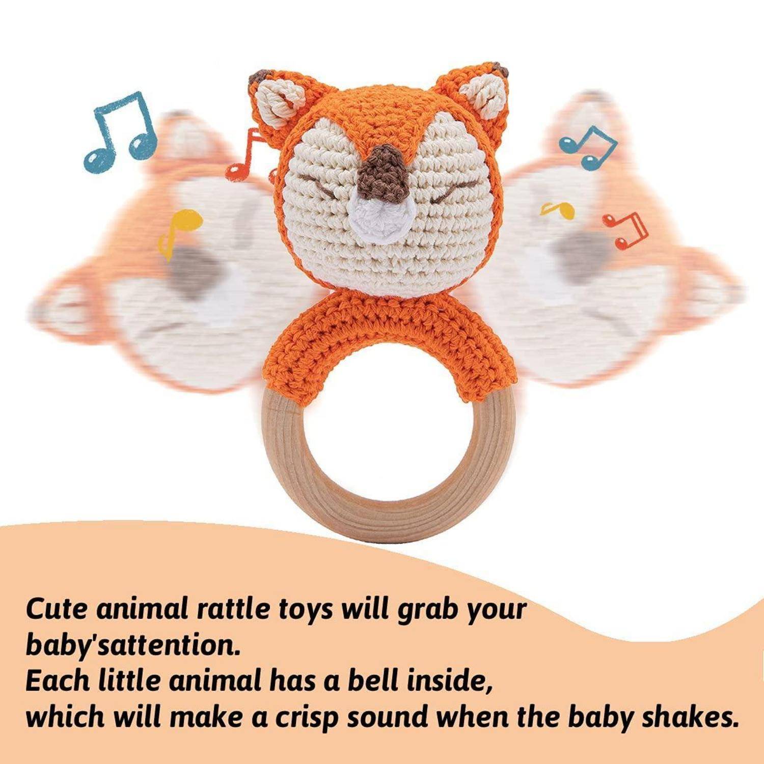 Gestrickter Fuchs-Babyrassel-Spielzeug mit Holzring und Glocke, dargestellt mit Musiknoten und Werbetexte über beruhigenden Klang und aufmerksamkeitsgreifenden Sound.