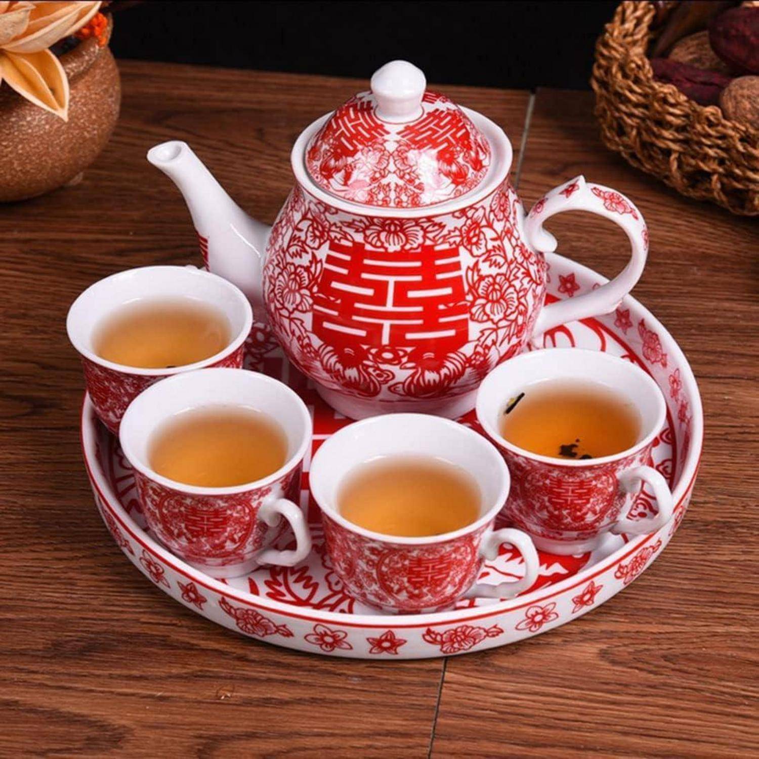 Rot-weiße Teeset mit einer Teekanne und vier gefüllten Tassen auf einem passenden Tablett, verziert mit einem chinesischen Doppelglück-Hochzeitssymbol.