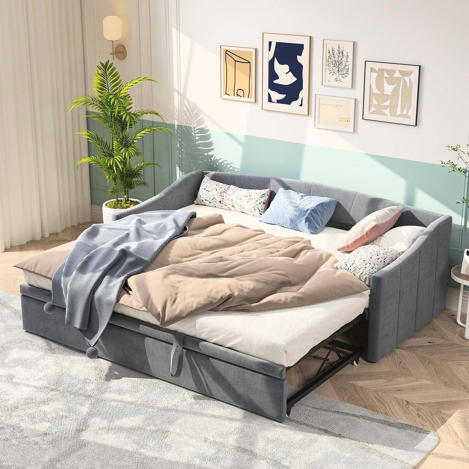 Graues Eck-Schlafsofa mit ausziehbarem Trundelbett und Kissen in einem hellen Wohnzimmer mit Wandkunst und Topfpflanze