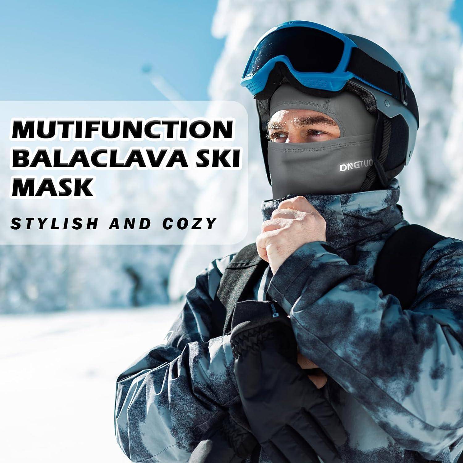 Mann mit blauem Ski-Helm und schwarzer Sturmhaube in schneebedeckten Bergen; der Anzeigentext besagt „MULTIFUNKTIONALE STURMHAUBE SKI-MASKE