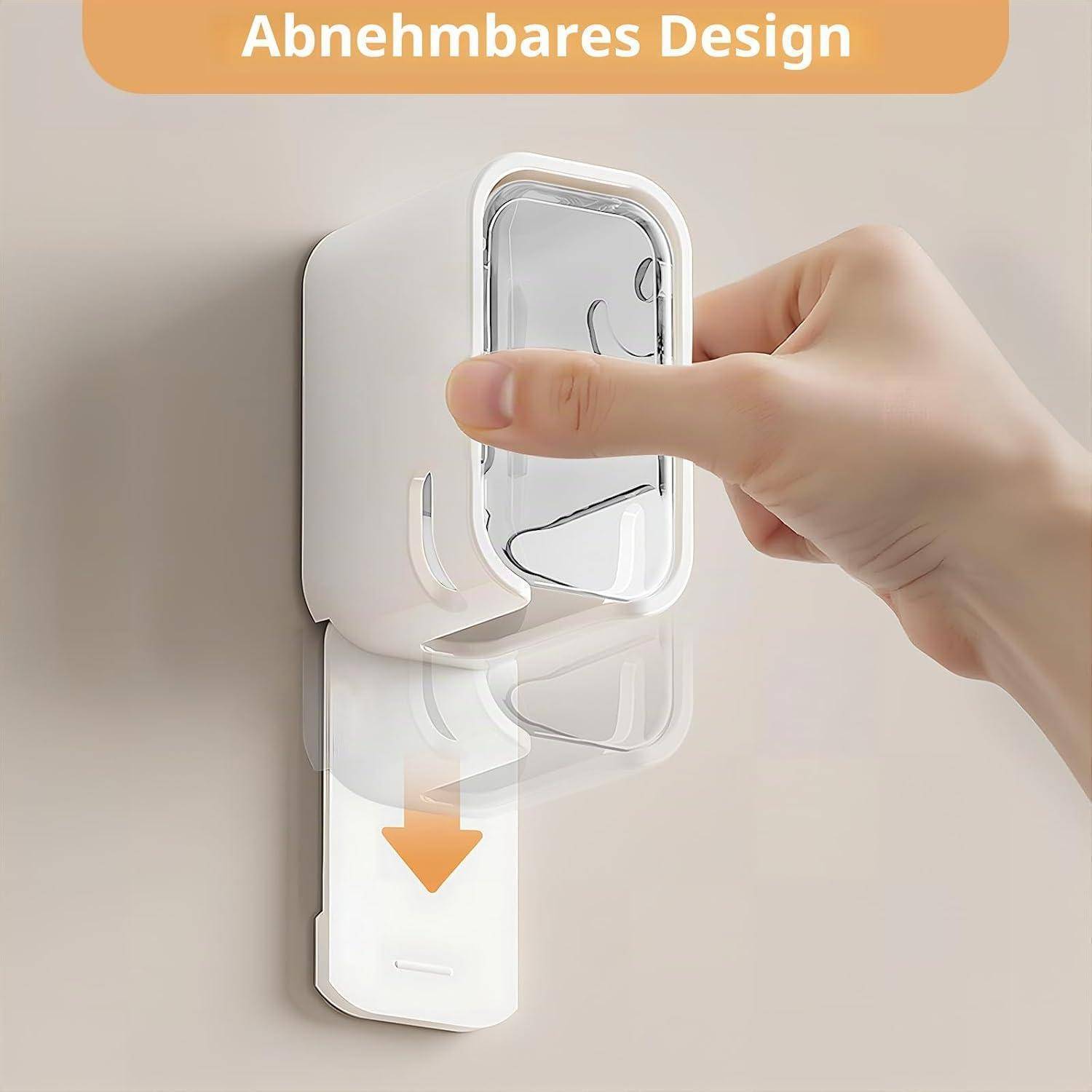 Hand entfernt einen durchsichtigen, wandmontierten Behälter mit der Bezeichnung 'Abnehmbares Design' und zeigt das abnehmbare Design mit einem nach unten zeigenden Pfeil.