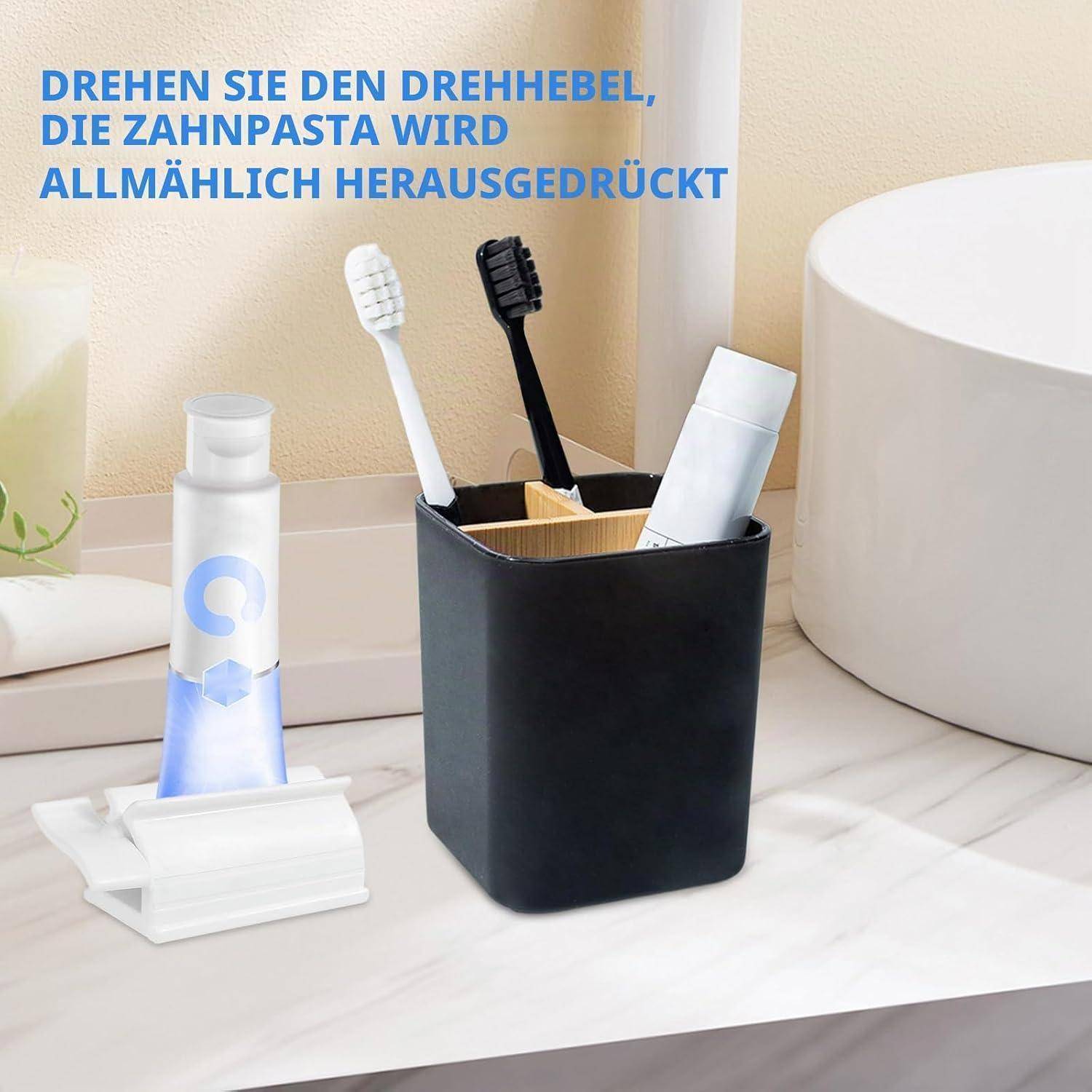 Badezimmer-Arbeitsplatte zeigt einen Zahnpasta-Tubenklemmer neben einem Zahnbürstenhalter; der deutsche Text sagt: „Drehen Sie den Kurbelhebel, die Zahnpasta wird allmählich herausgepresst.