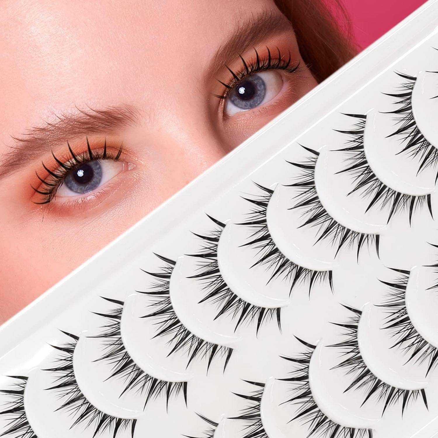 Nahaufnahme der Augen einer Frau mit langen Wimpern neben einem Fächer von künstlichen Wimpernstreifen, die Beauty-Make-up-Produkte zeigt.