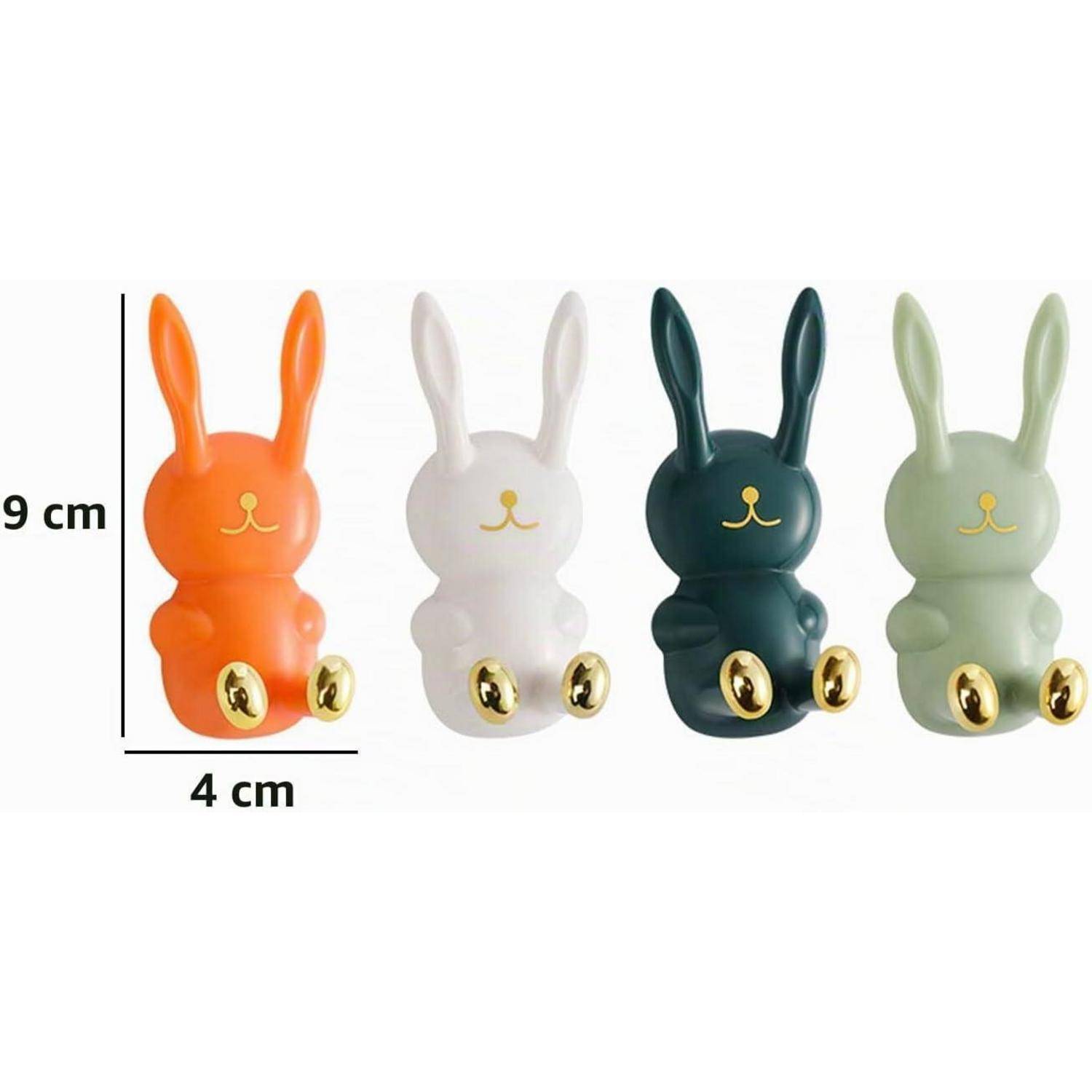 Bild von vier kleinen kaninchenförmigen Figuren in Orange, Weiß, Dunkelgrün und Hellgrün, gezeigt mit Größenangaben von 9 cm Höhe und 4 cm Breite.