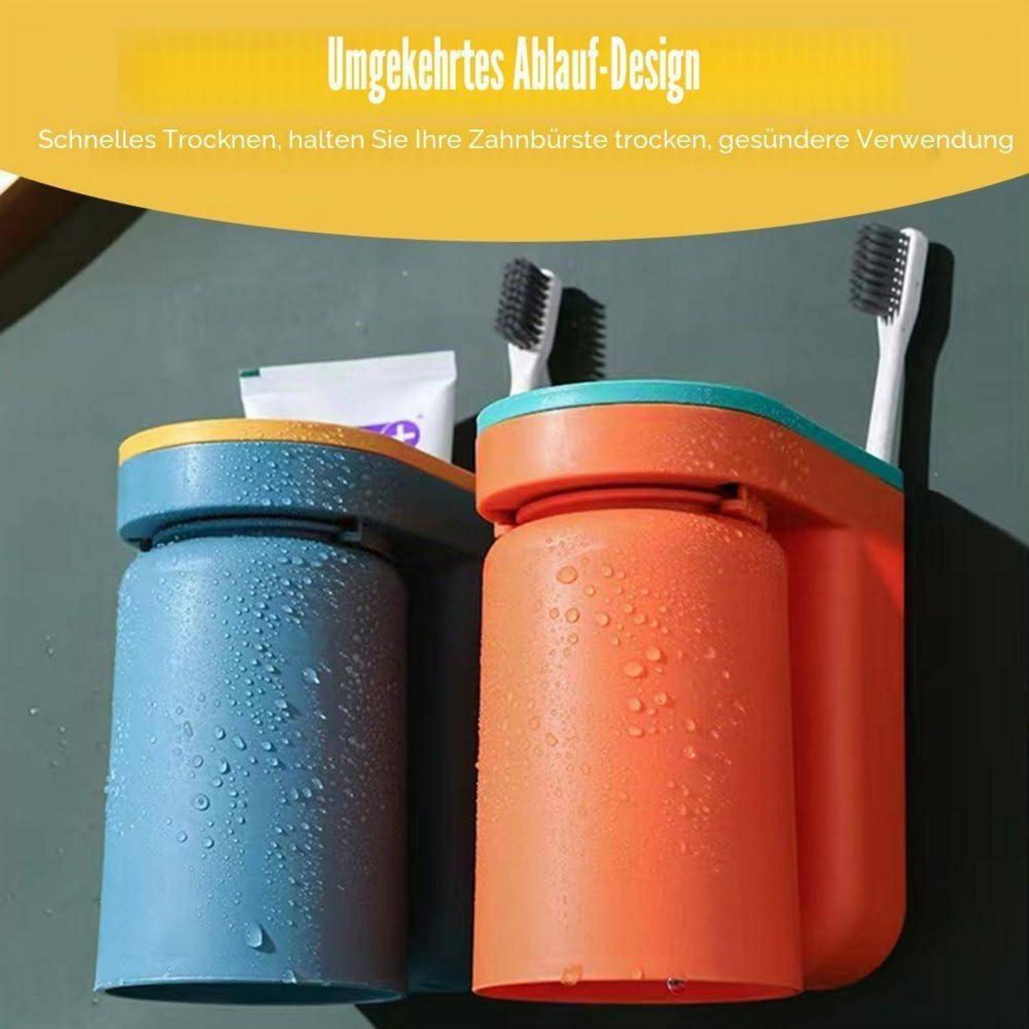 Zwei an der Wand montierte Zahnbursthalter in Blau und Orange mit Zahnbürsten und Zahnpasta, gezeigt mit Wassertropfen zur Förderung schneller Trocknung und hygienischer Lagerung.