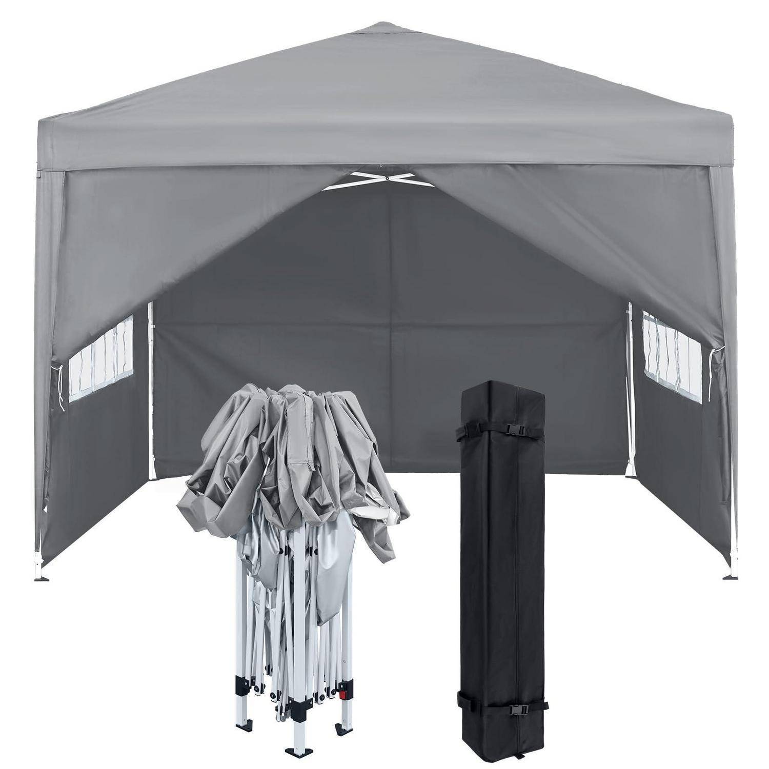 Graugrauer Pop-up-Baldachindachzelt mit Seitenwänden, teilweise zusammengebaut gezeigt, mit zusammengeklapptem Gestell und schwarzer Tragetasche davor.