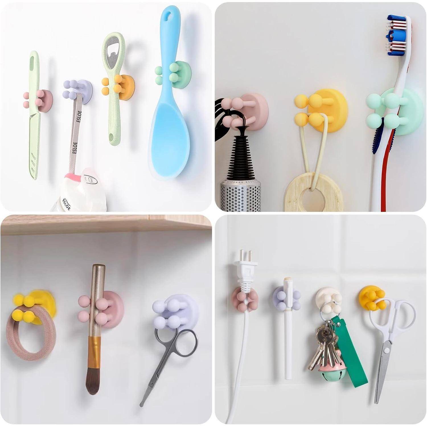 Bunte klebbare Wandhaken halten Zahnbürsten, Pflegeutensilien, Haartrockner, Bürste, Schlüssel und Schere in einer vierteiligen Displayanzeige.