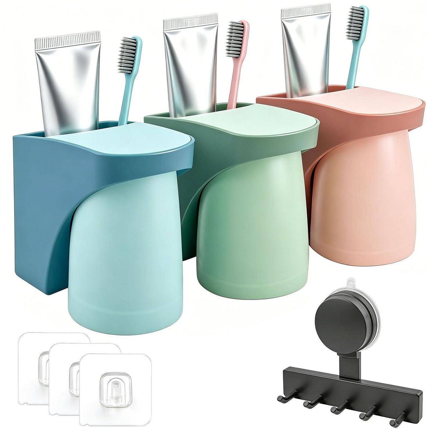 Pastellfarbene wandmontierte Badezimmerorganizer mit Zahnbürsten und Zahnpastatuben, plus Klebehaken und eine schwarze Mehrhaken-Leiste.
