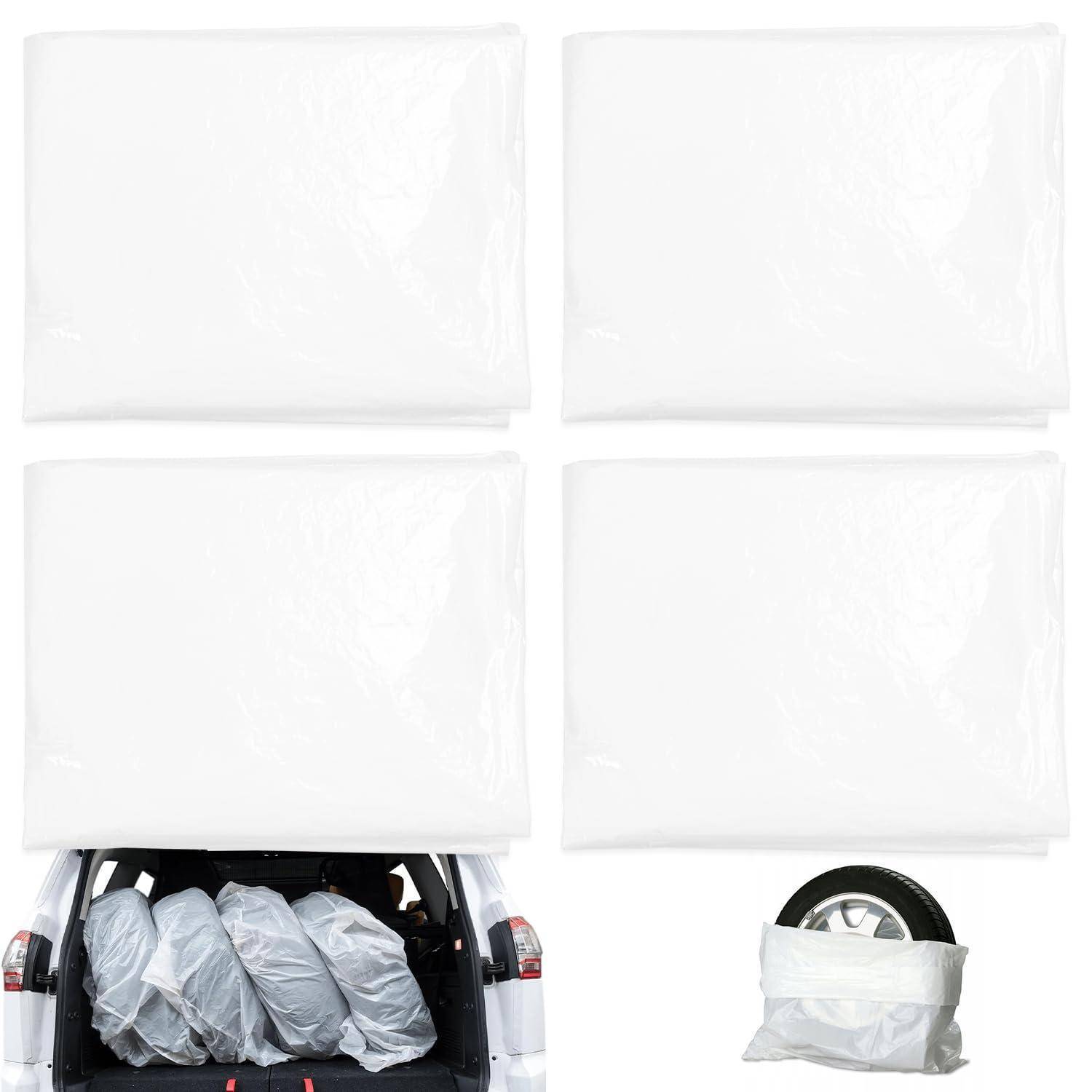 Test der Entfaltung des weißen Schutzairbags, zeigt vier aufgeblasene Airbags über einem Auto und ein mit Schutzabdeckung umwickeltes Rad vor weißem Hintergrund.