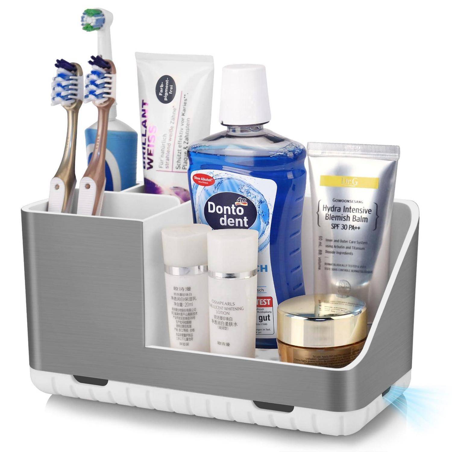 Badezimmer-Arbeitsplatte-Organizer, der zwei Zahnbürsten, Zahnpasta, Mundwasser, Hautpflege-Tuben, Flaschen und ein Cremeglas hält.