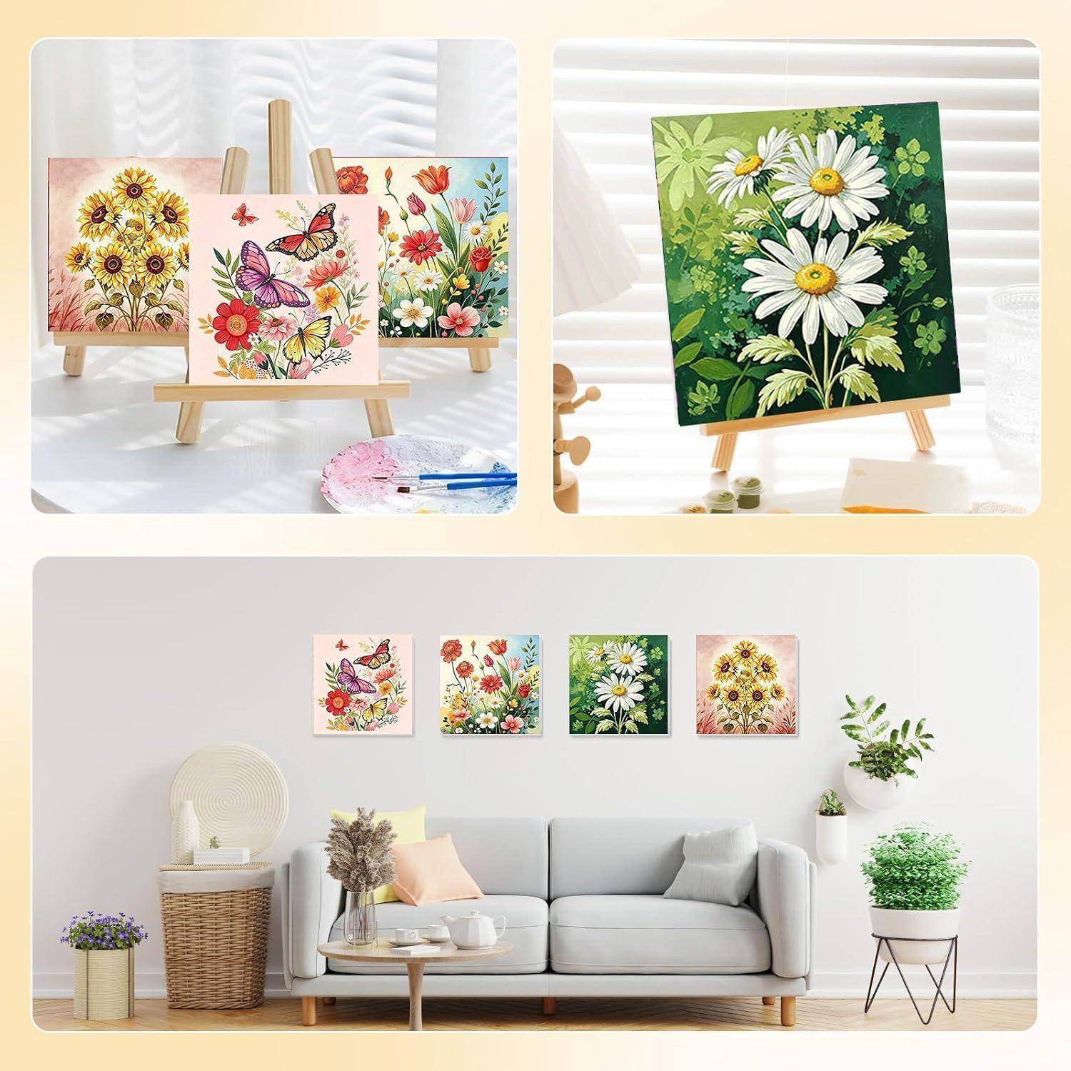 Dekorative Blumenmalereien auf Staffeleien und als kleine Wandkunst über einem grauen Sofa in einem hellen Wohnzimmer angebracht.