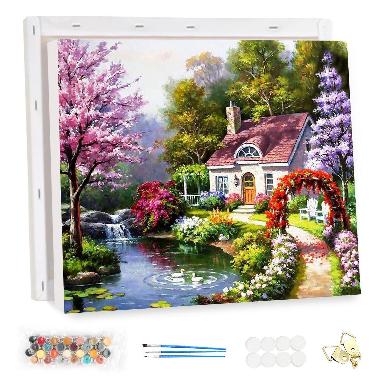 Diamantmalerei im Rahmen eines Cottage-Gartens mit Blumen, einem Teich und Schwänen, gezeigt mit enthaltenen Perlen, Applikatoren, Wachspads und Tablett.