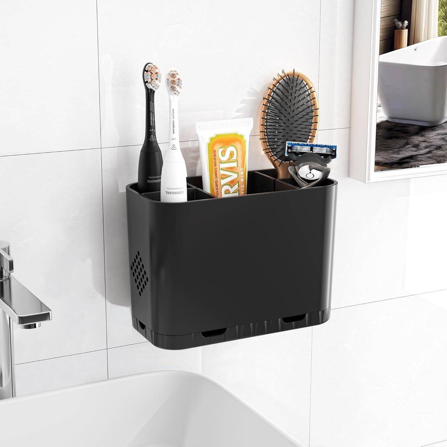 An der Wand montierter Badezimmerorganizer, der zwei elektrische Zahnbürsten, Zahnpasta, eine Haarbürste und einen Rasierer neben einem Waschbecken und einem Spiegel hält.