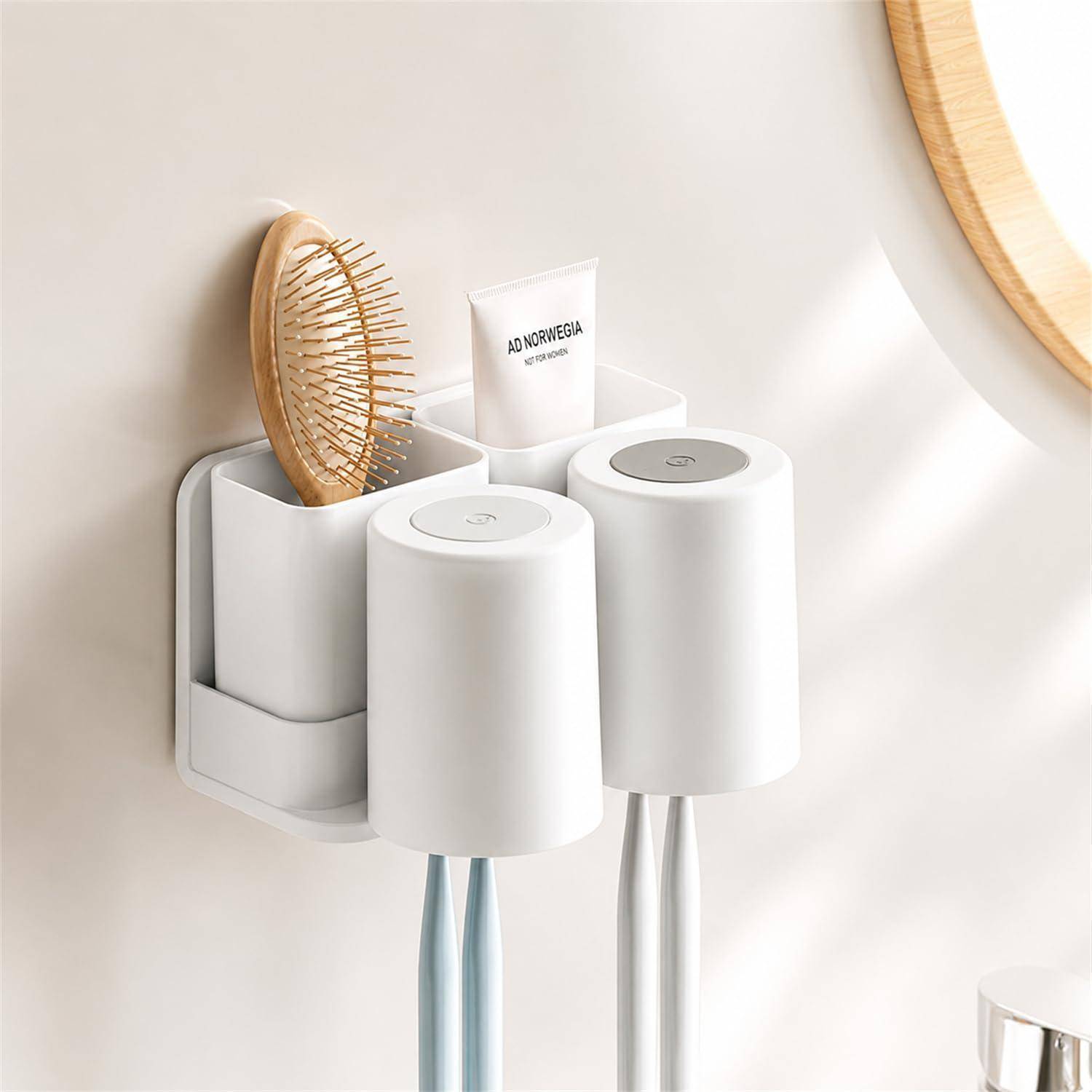 An der Wand montiertes Badezimmerorganizer, das eine Haarbürste, Zahnpasta und zwei Zahnbürsten in separaten weißen Behältern enthält.