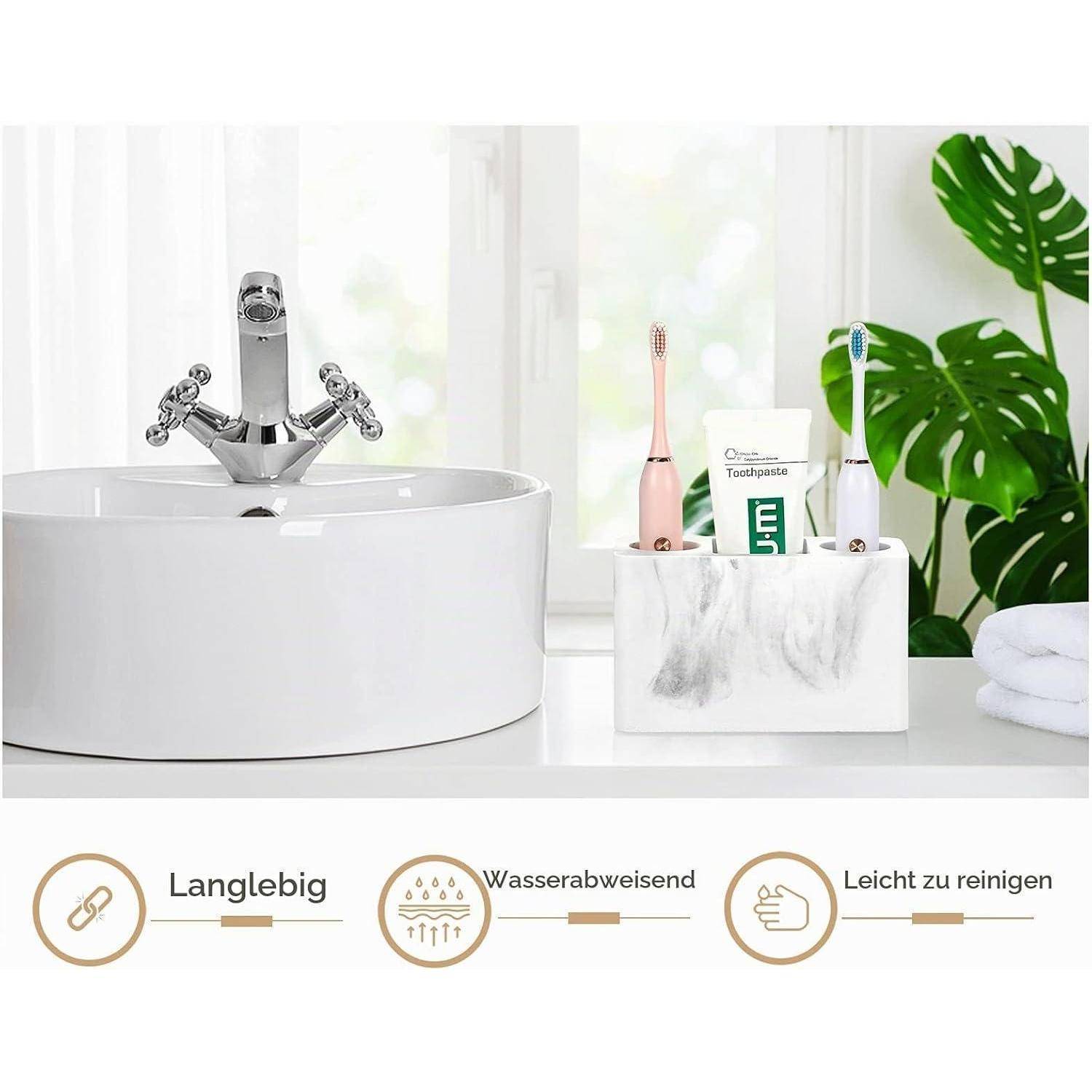 Waschbecken im Badezimmer mit Chromarmatur neben einem marmorierten Organizer, der Zahnbürsten und Zahnpasta hält; Bildunterschrift hebt „Langlebig