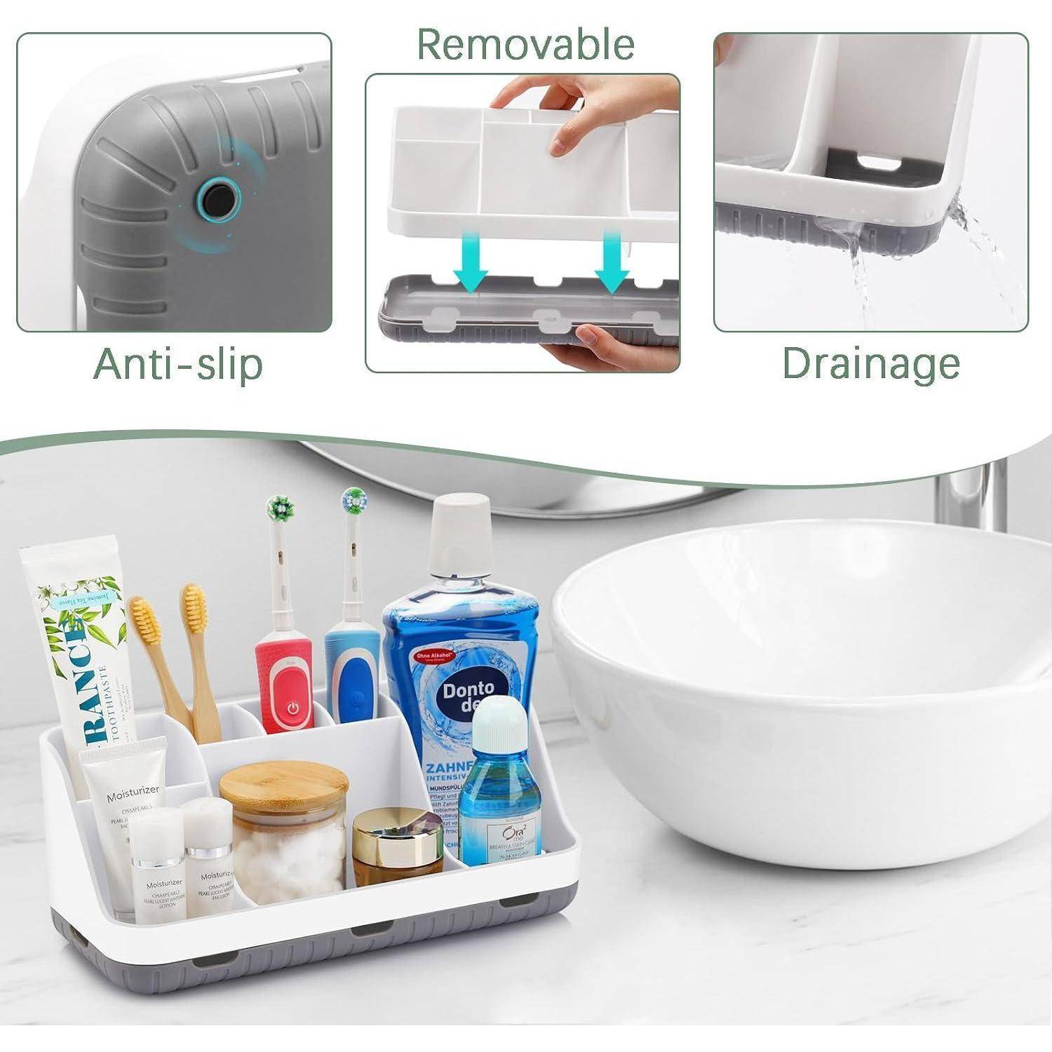 Badezimmer-Arbeitsplatte Organizer-Tablett mit rutschfester Basis, abnehmbarem Einsatz und Drainage, mit Zahnbürsten, Toilettenartikeln und Zahnpasta neben einer Spülschüssel.