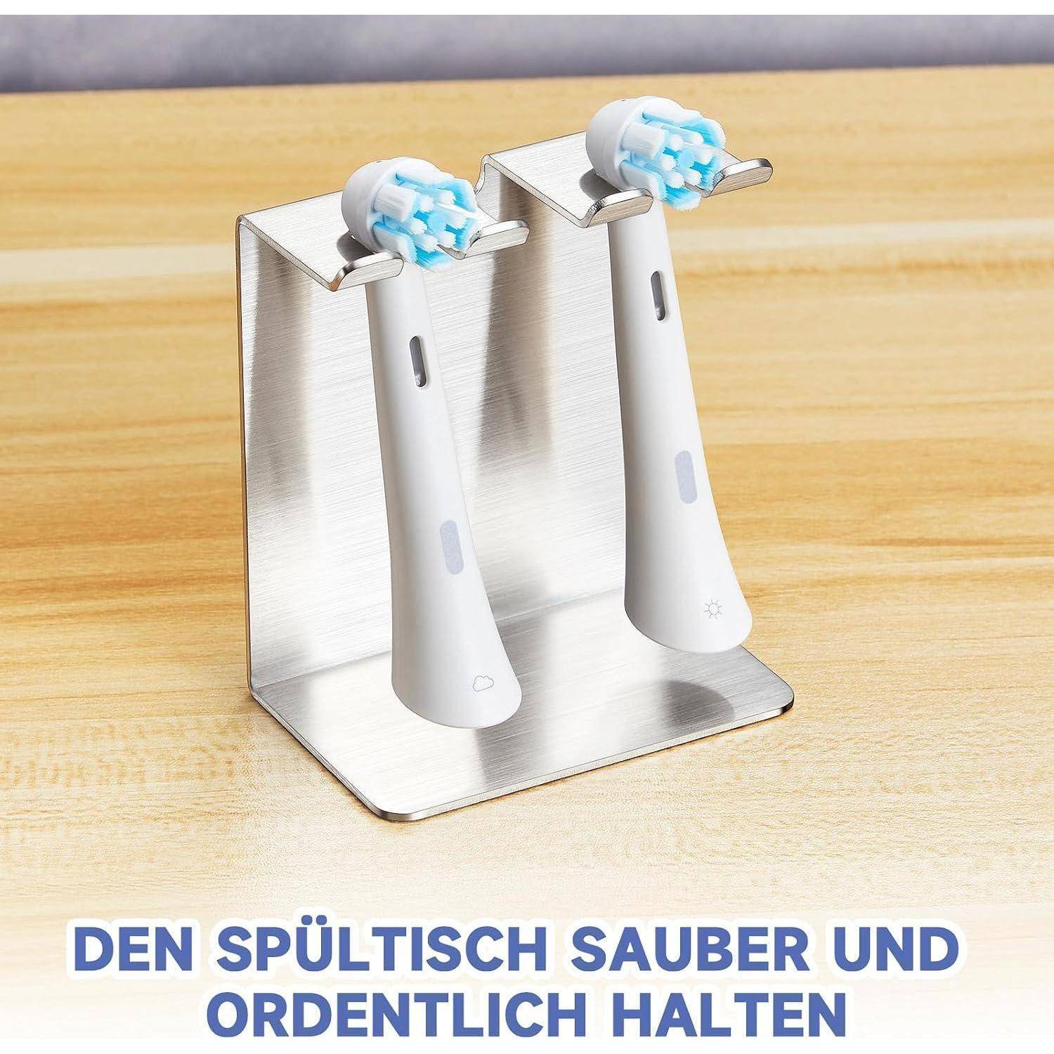 Zwei elektrische Zahnbürsten auf einem Edelstahlhalter auf einer Arbeitsplatte, mit deutschem Text: „Halten Sie das Waschbecken ordentlich und sauber