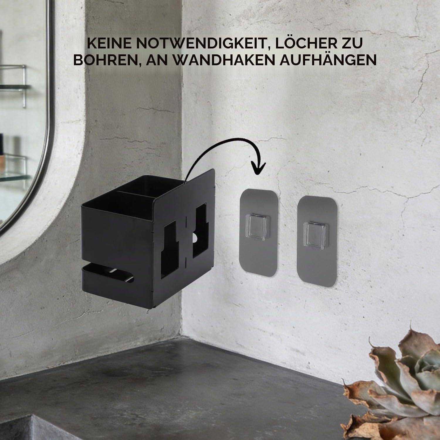 Schwarze wandmontierte Aufbewahrungsbox, die sich an Klebehaken befestigt, mit deutschem Text, der angibt, dass kein Bohren oder Wandhaken erforderlich sind.