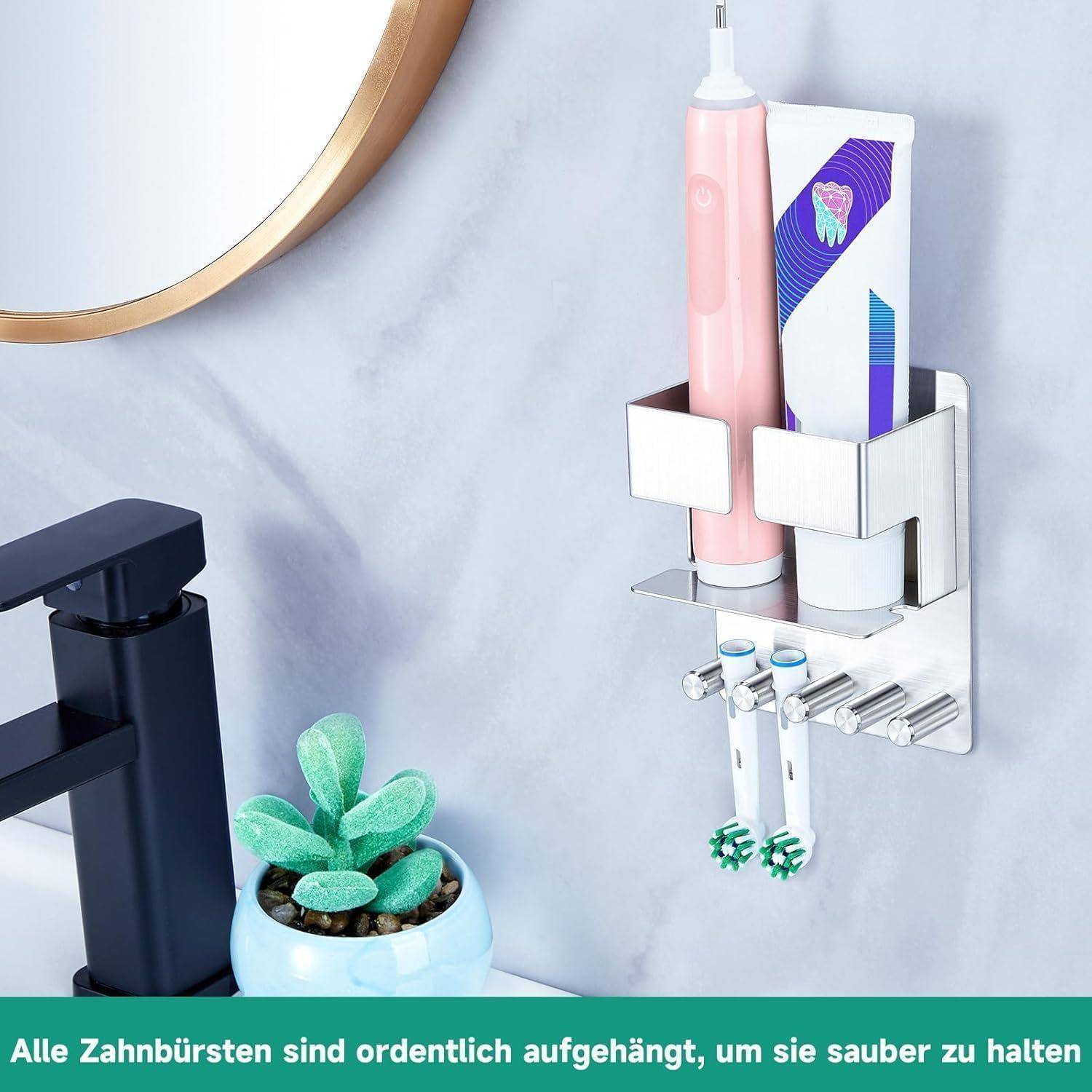 Badezimmer-Wandorganizer, der eine Zahnbürste, Zahnpasta, Ersatzköpfe für elektrische Zahnbürsten und einen rosa Spender neben einem Waschbecken hält.