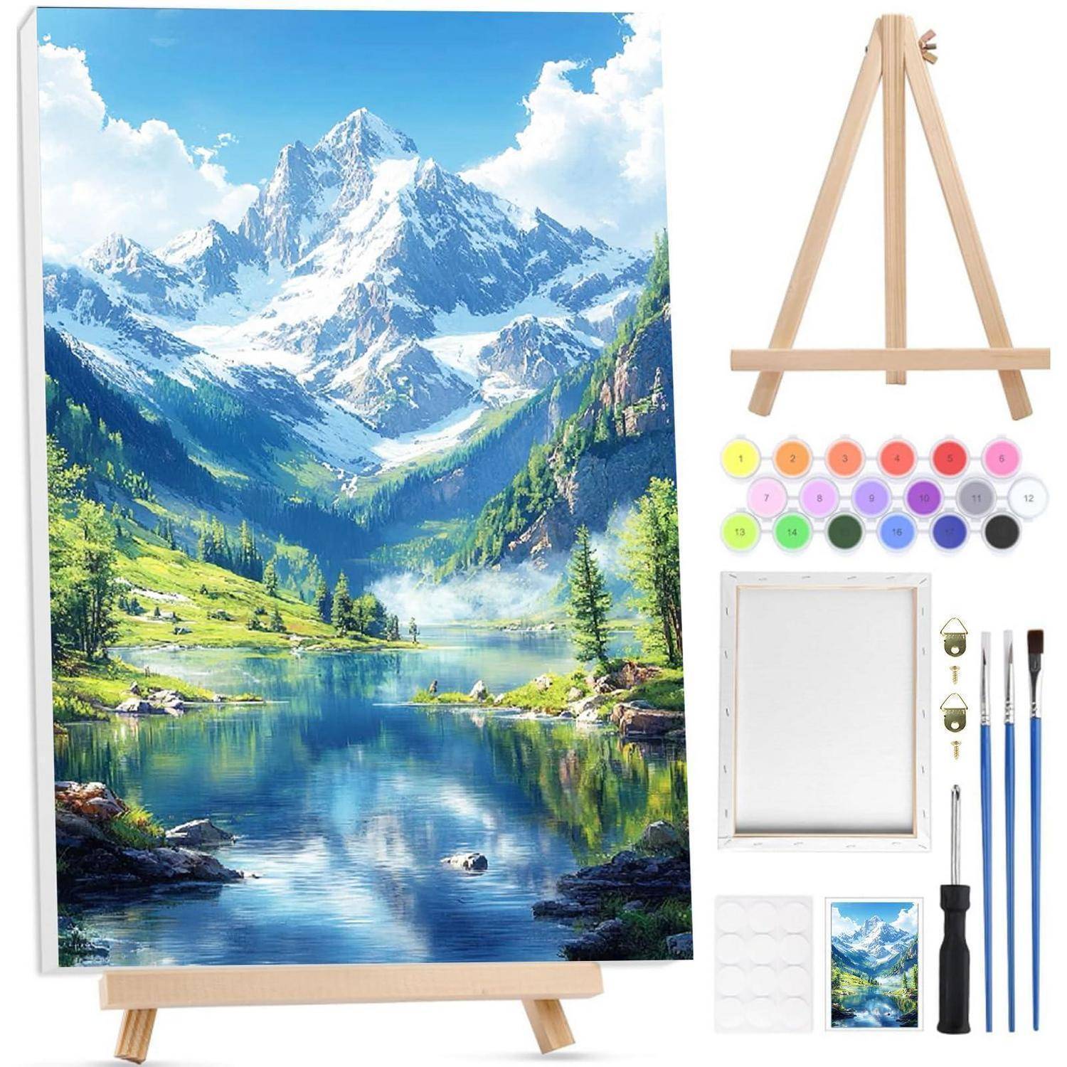 Malset mit Staffelei, leerer Leinwand, Farbdosen, Pinseln und Referenzfoto; fertige Bergseenlandschaft auf Leinwand ausgestellt.