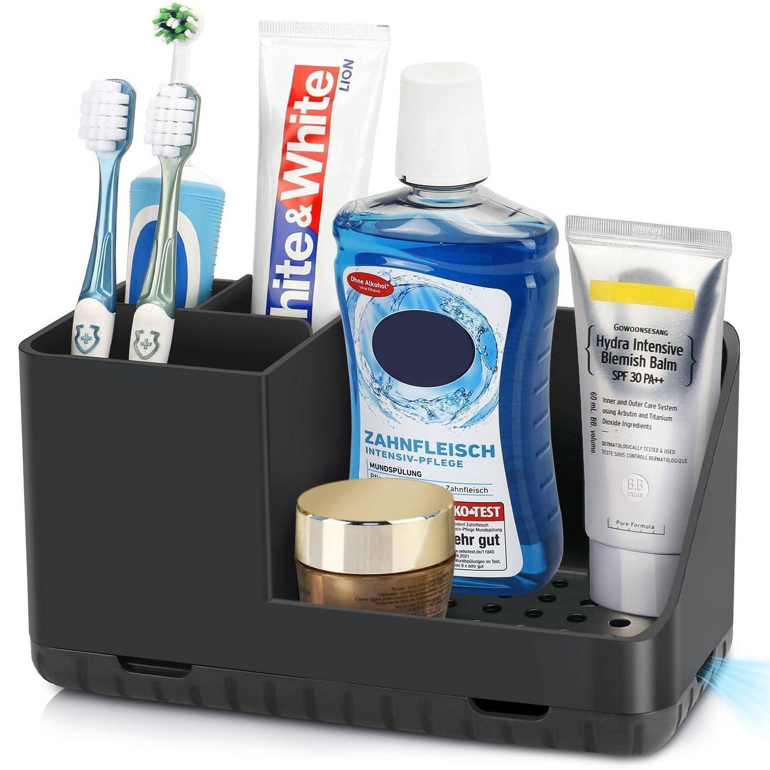 Badezimmer-Organizer mit zwei Zahnbürsten, Zahnpasta, Mundwasser, Gesichtscreme und einem Hautbalsam in Tubenform auf einem schwarzen Organizer-Tablett.