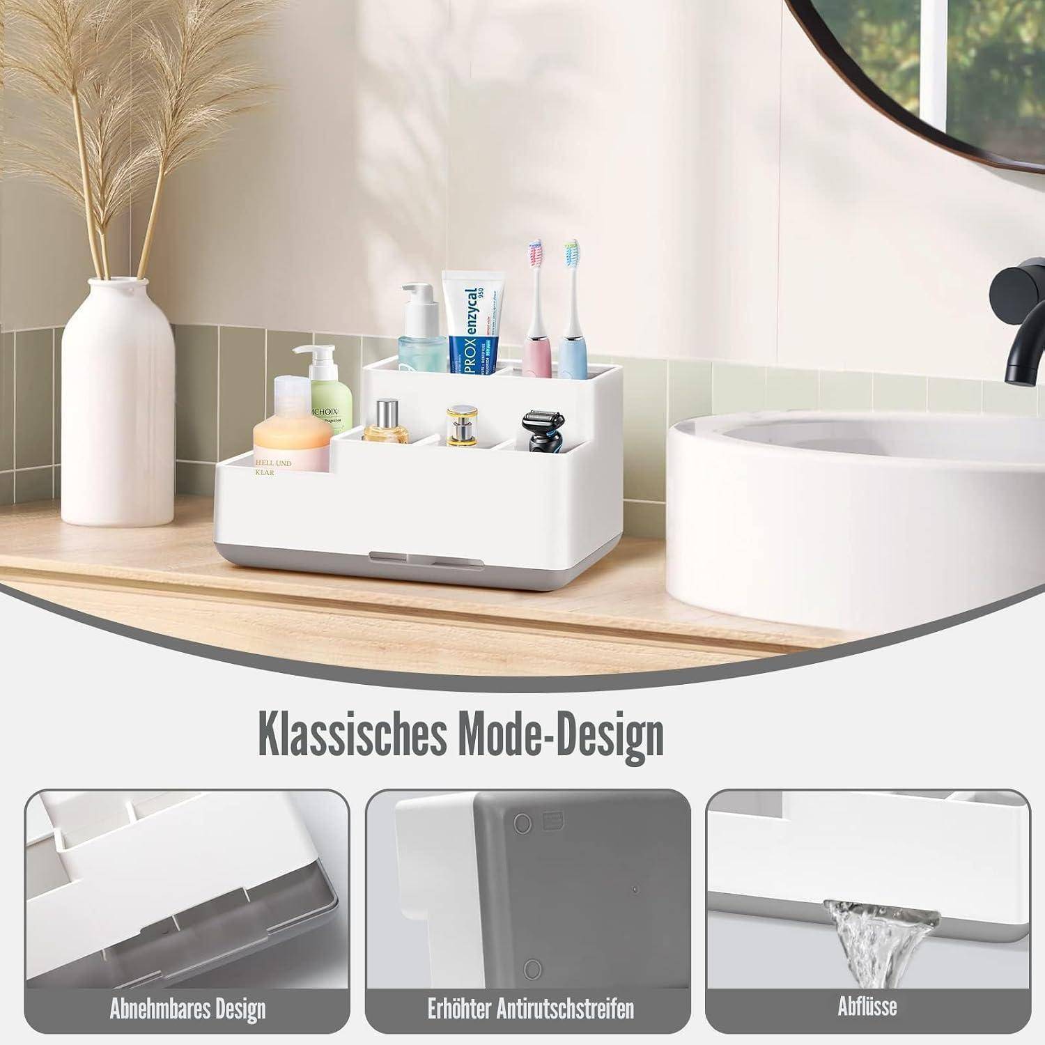 Badezimmer-Arbeitsplatte Organizer mit Toilettenartikeln und Zahnbürsten; untere Paneele zeigen ein abnehmbares Design, erhabene Antirutsch-Leiste und Entwässerungsschlitze, mit Beschriftung auf Deutsch.