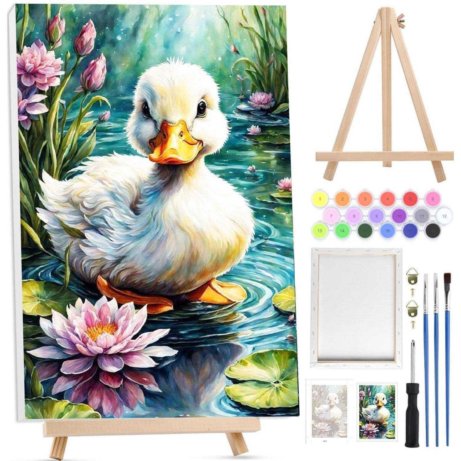 Malbuch-Set mit einer Ente in einem Teich mit rosa Seerosen, daneben eine Staffelei, nummerierte Farbdosen, Leinwand, Pinsel und Referenzbilder.